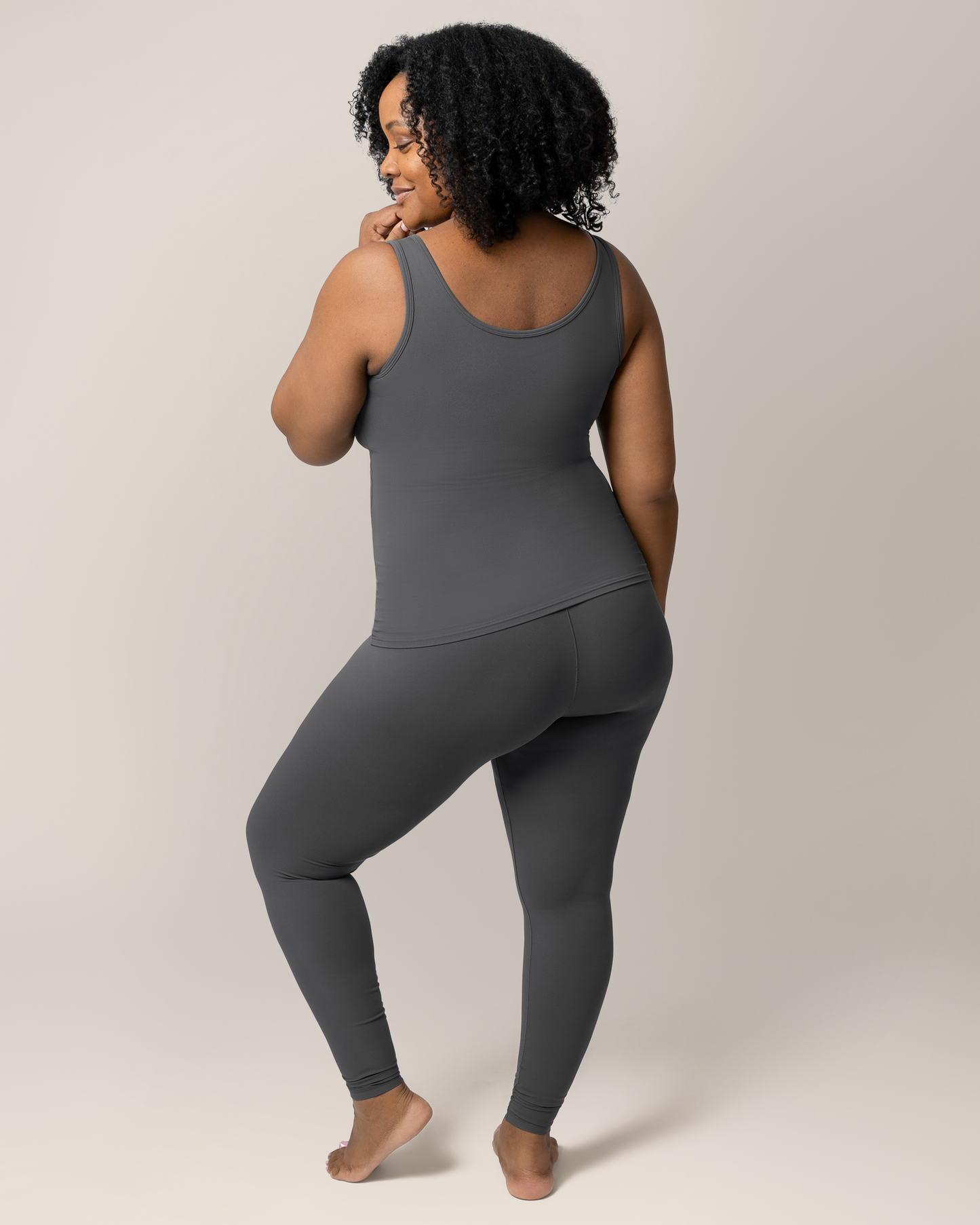 Back view of model wearing the Grow with Me™ Maternity & Postpartum Legging in Stormy Grey paired with matching Grow with Me™ Maternity & Nursing Tank