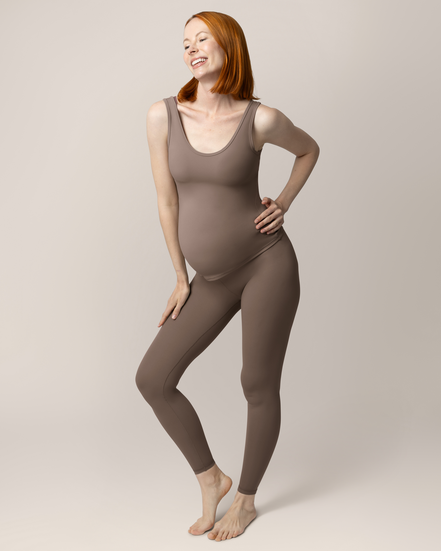 Pregnant model wearing the Grow with Me™ Maternity & Nursing Tank in Taupe, paired with matching Grow with Me™ Maternity & Postpartum Legging