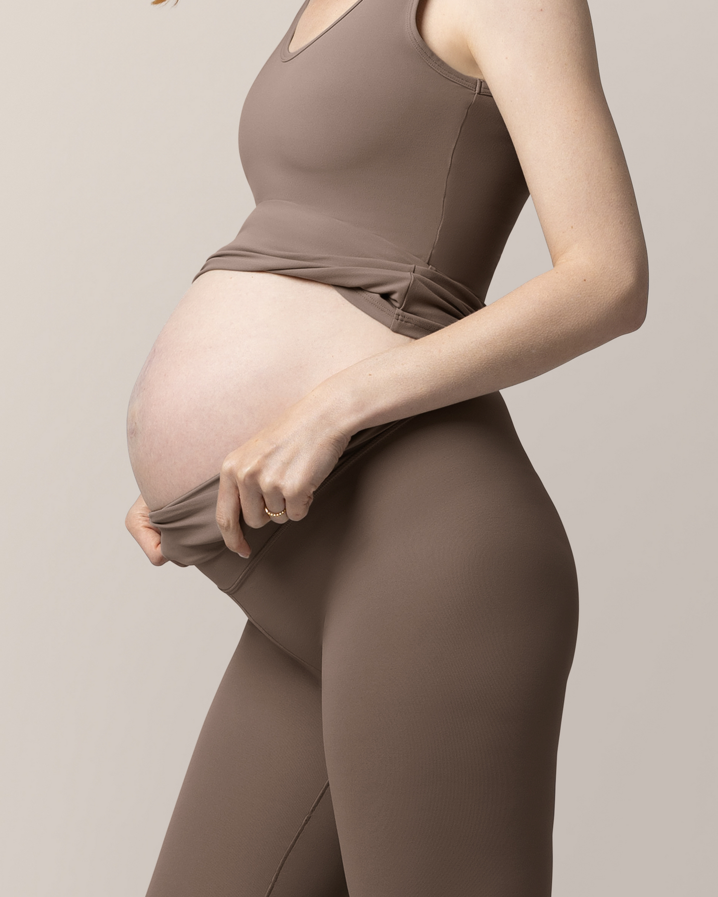 Close up view of pregnant model wearing the Grow with Me™ Maternity & Postpartum Legging in Taupe, showing waistband folded down @model_info:Anna is 5'10" and wearing a Small.