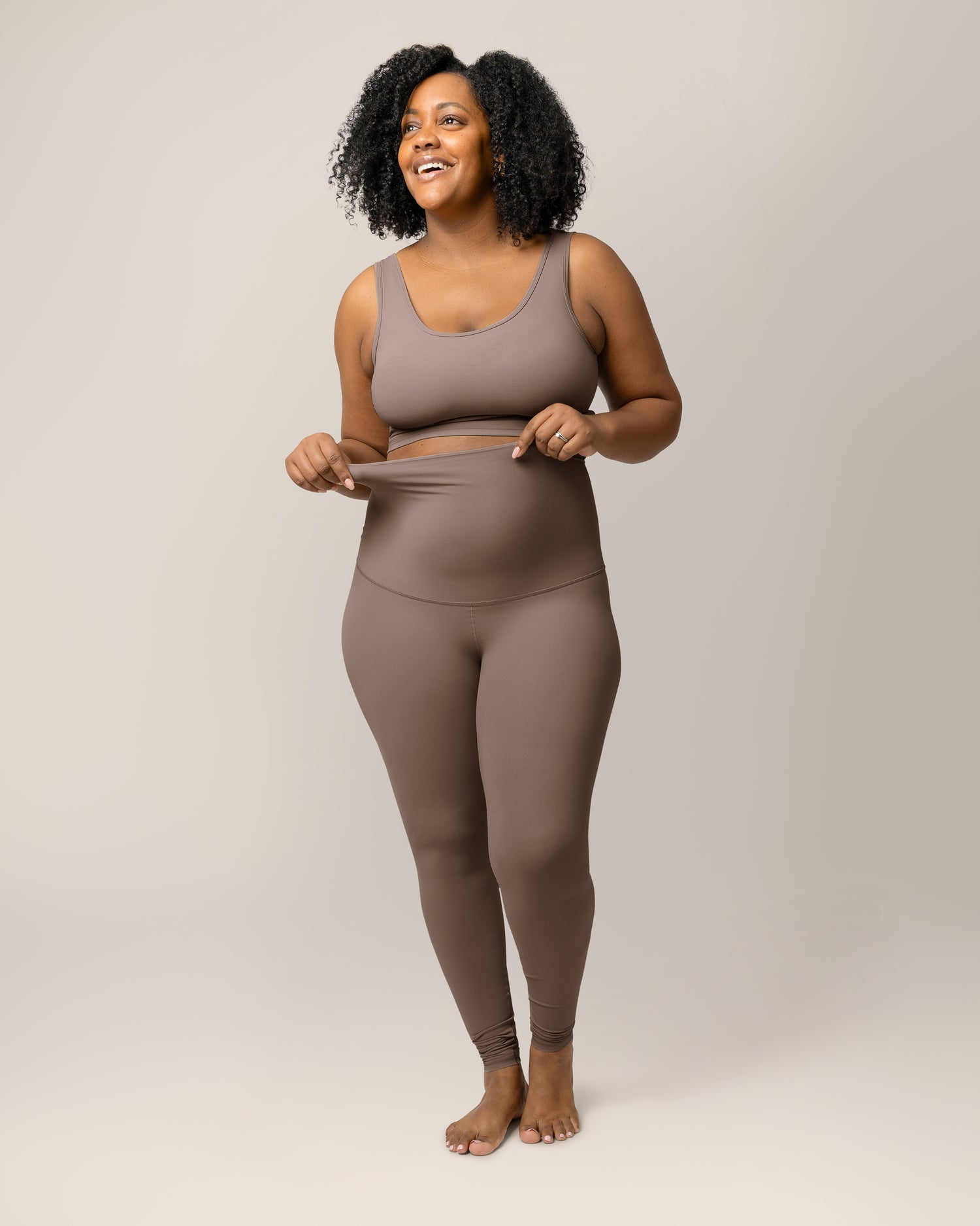 Close up of model wearing the Grow with Me™ Maternity & Postpartum Legging in Taupe, showing strech of the waistband. @model_info:Roxanne is 5'8" and wearing a Large.