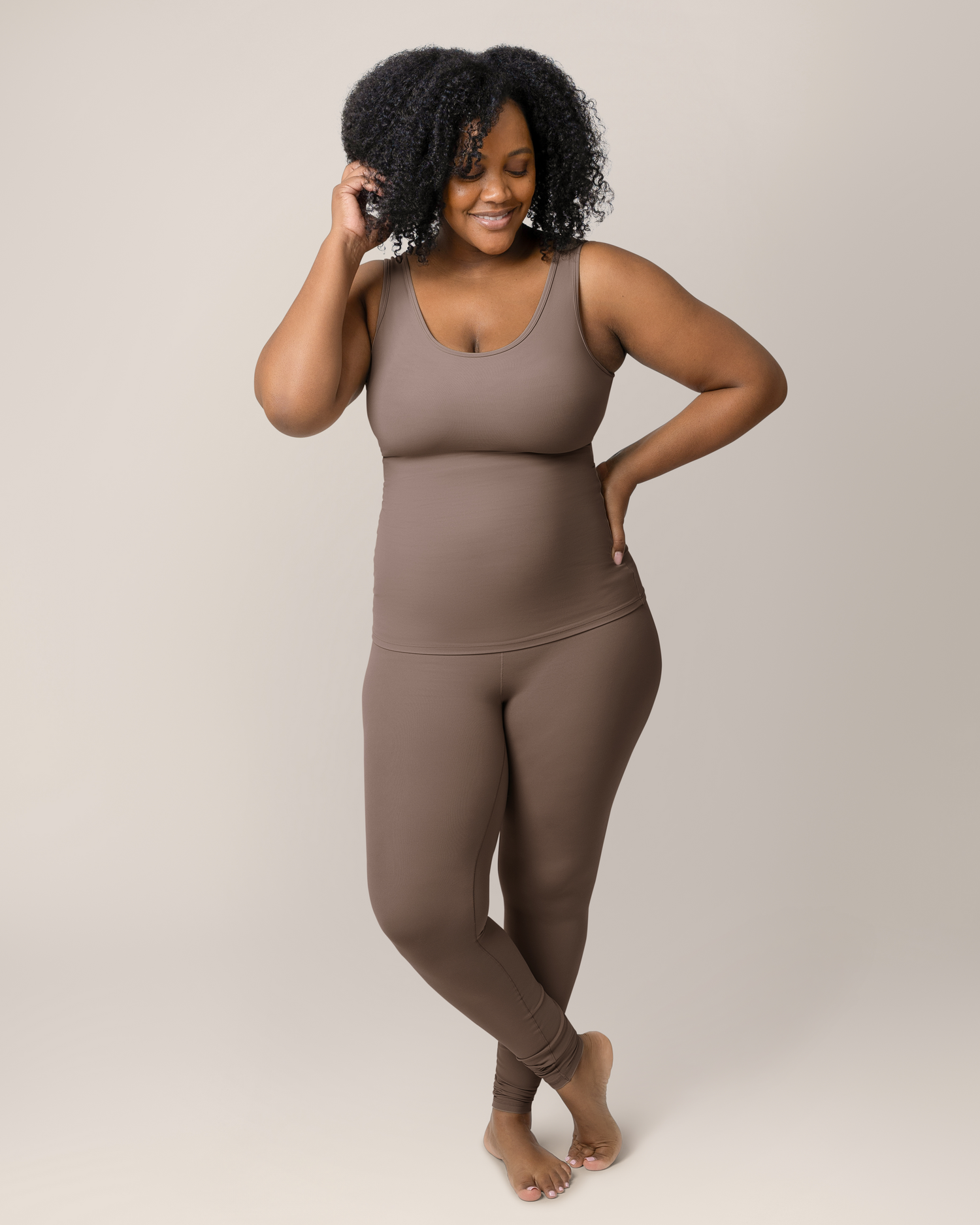 Front view of model wearing the Grow with Me™ Maternity & Postpartum Legging in Taupe paired with matching Grow with Me™ Maternity & Nursing Tank