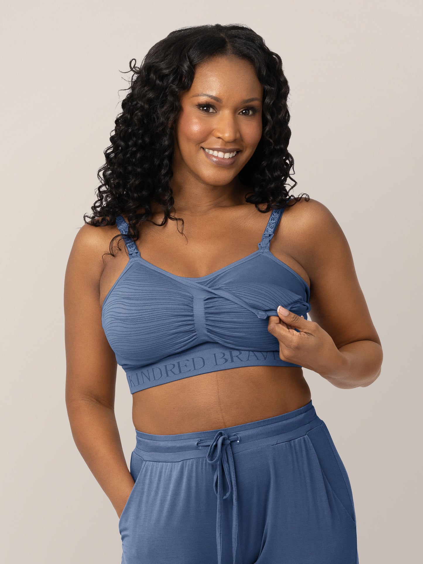 Front view of model wearing the Sublime® Hands-Free Pumping & Nursing Bra in Slate Blue, showing unclipping feature @model_info:Rashé is wearing a Large.