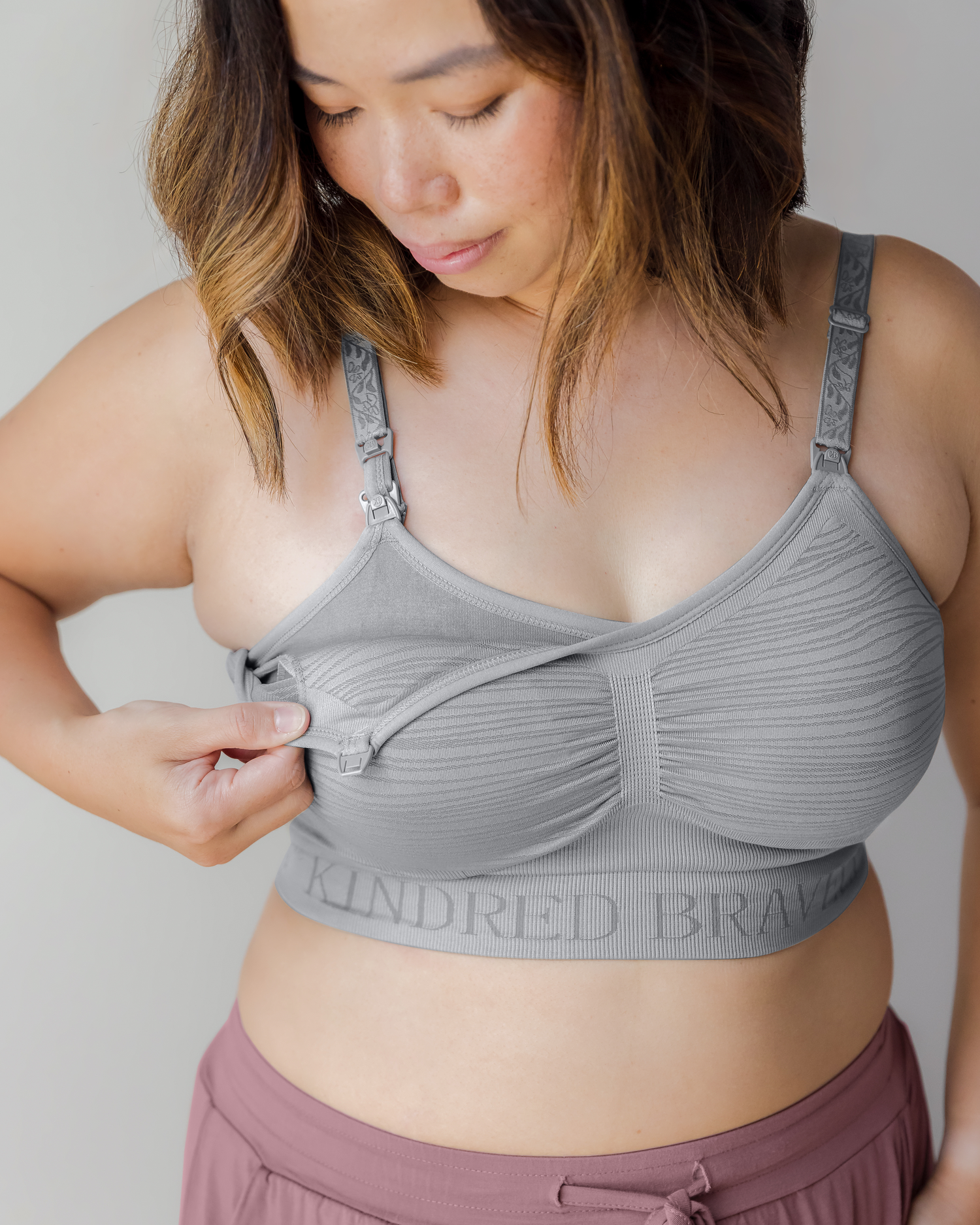 Model wearing the Sublime® Hands-Free Pumping & Nursing Bra in grey, showing clip-down pumping access