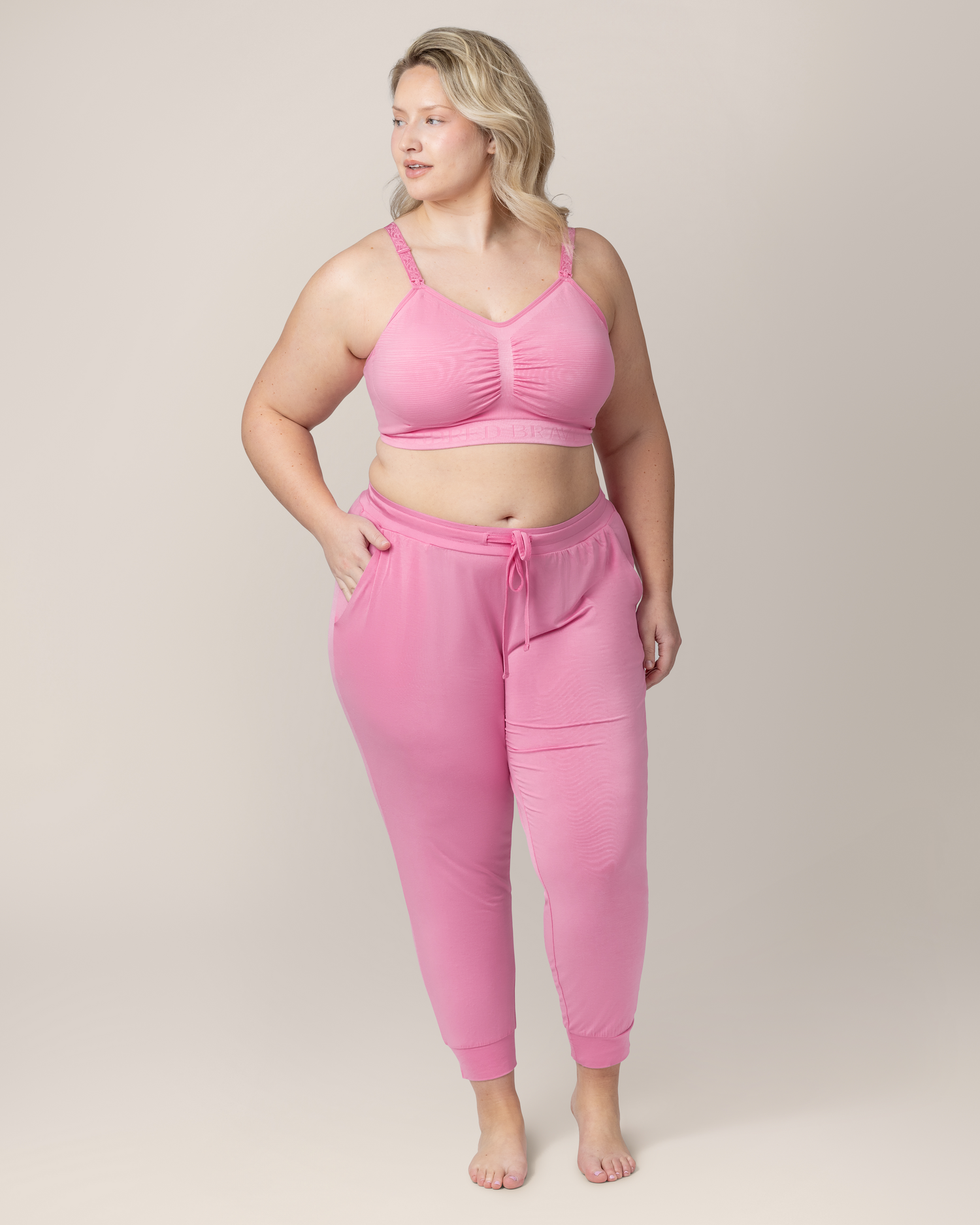 Front view of model wearing Everyday Lounge Jogger in Bubblegum with matching Sublime® Hands-Free Pumping & Nursing Bra @model_info:Austen is 5'10" and wearing a 1X.