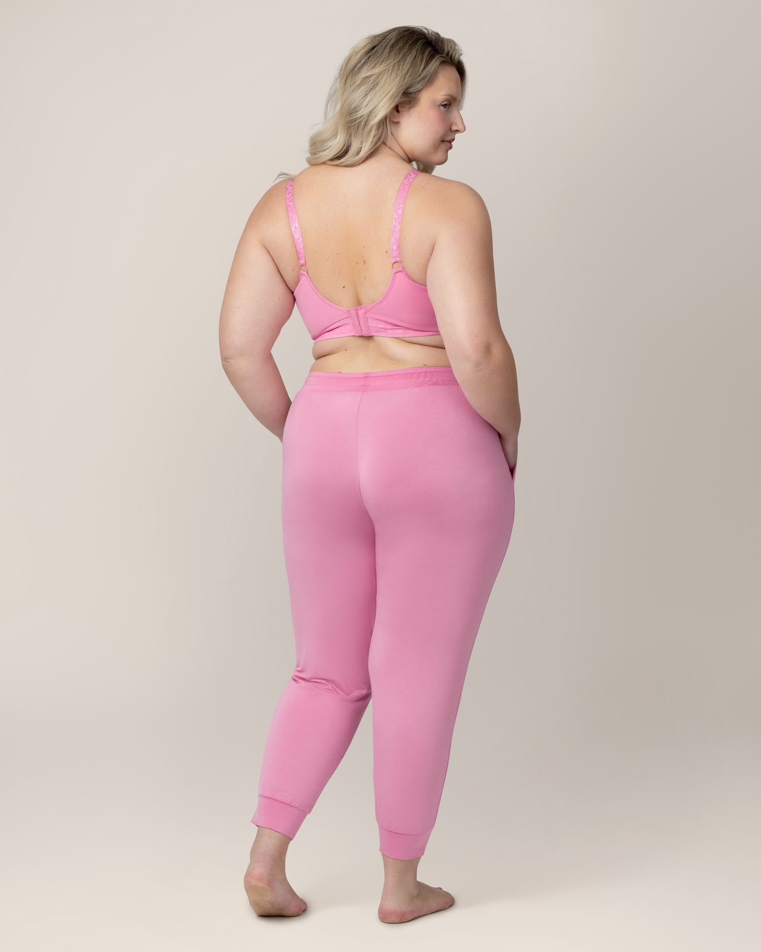 Back view of model wearing Everyday Lounge Jogger in Bubblegum with matching Sublime® Hands-Free Pumping & Nursing Bra 