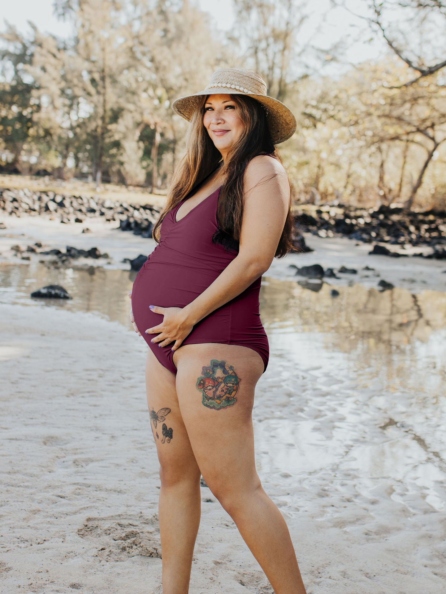 Full body image of pregnant model outside wearing the Gathered Maternity One Piece Swimsuit in Maroon