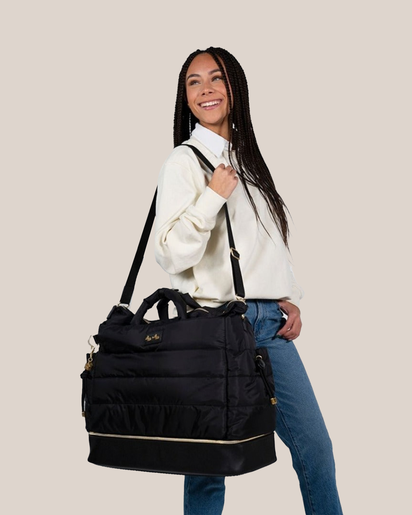 Model wearing the Itzy Ritzy - Dream Weekender™ Hospital & Travel Bag in Midnight Black on her shoulder