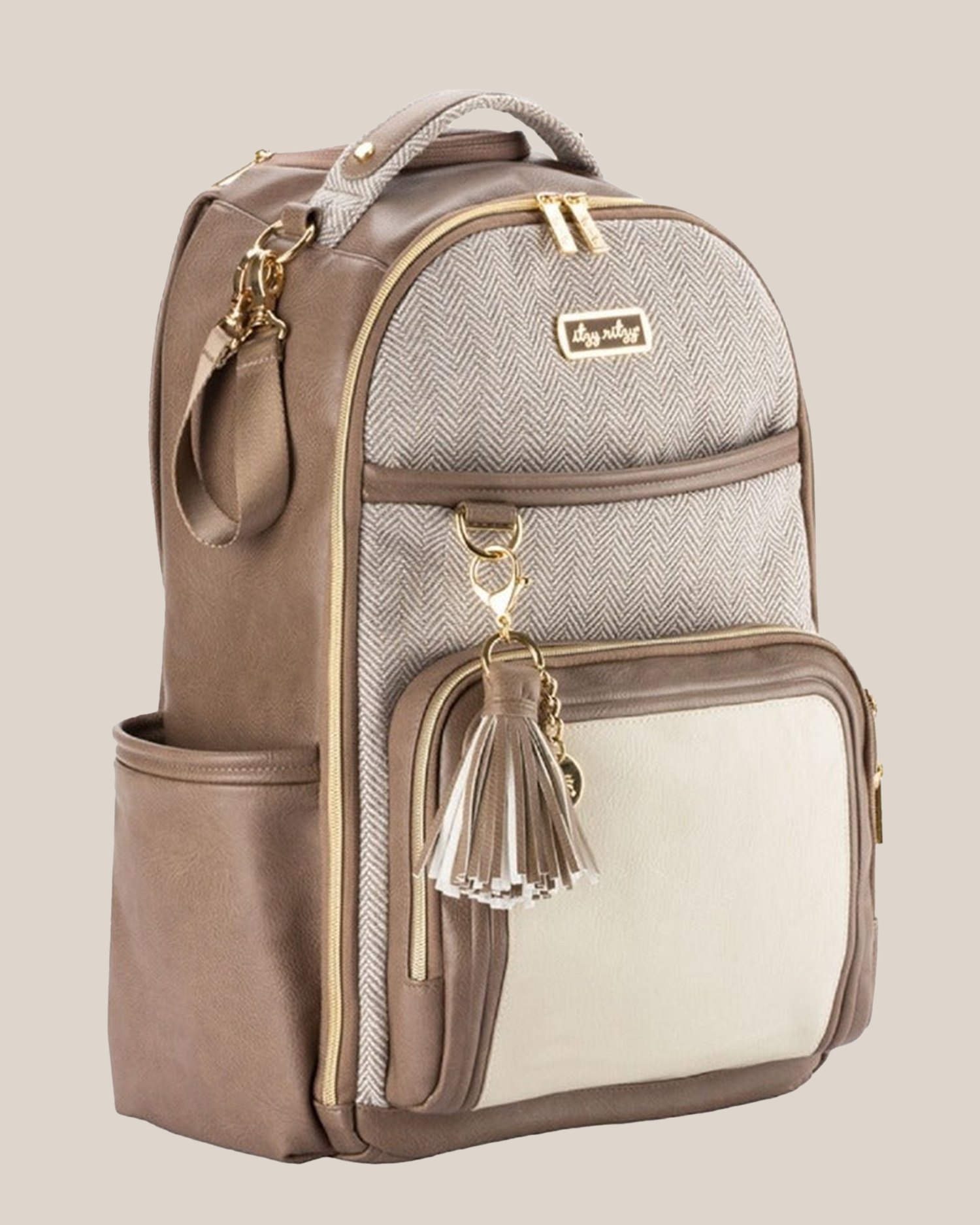 3/4 view of the Itzy Ritzy - Boss Plus™ Diaper Bag Backpack in Vanilla Latte