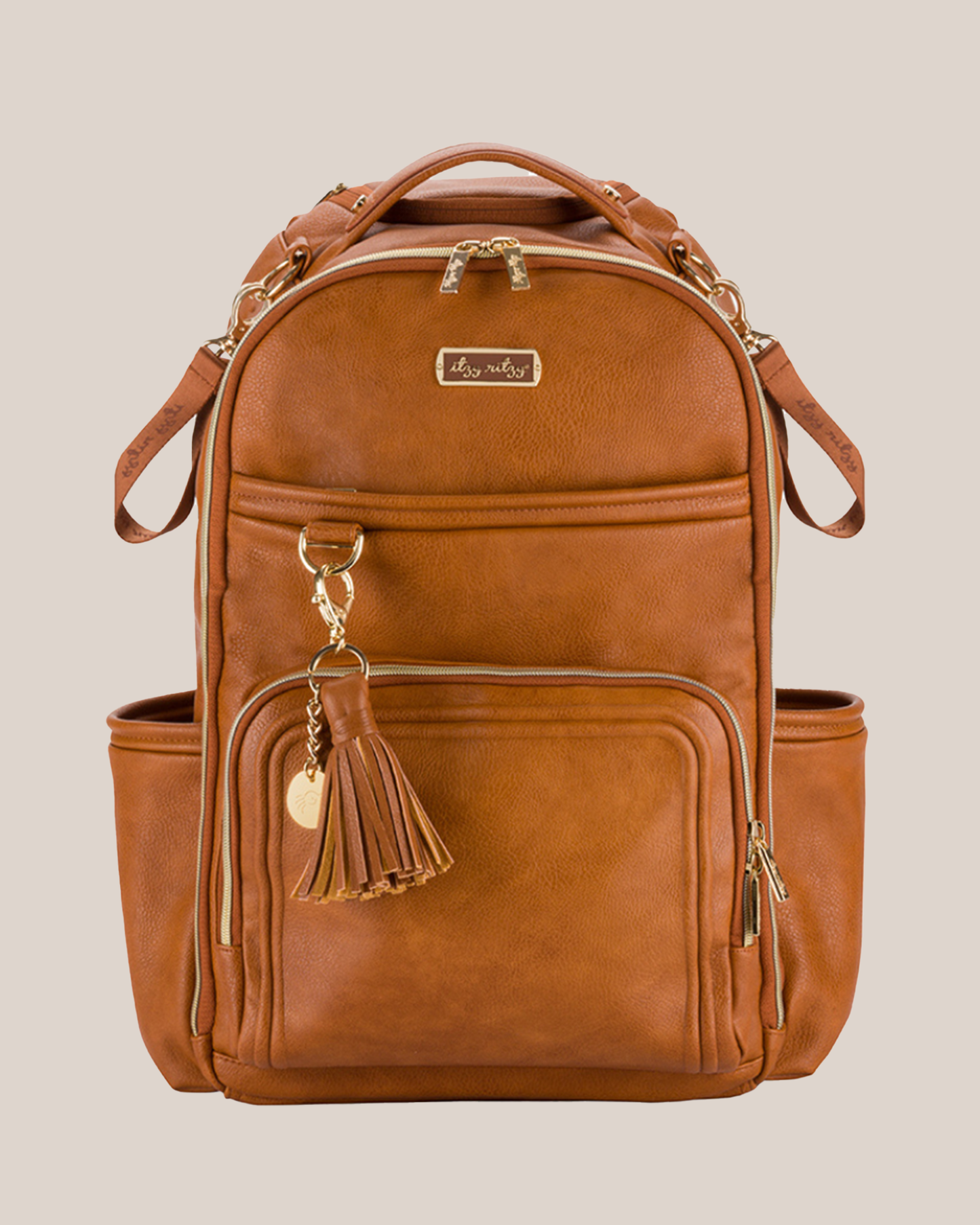 Front view of the Itzy Ritzy - Boss Plus™ Diaper Bag Backpack in Cognac