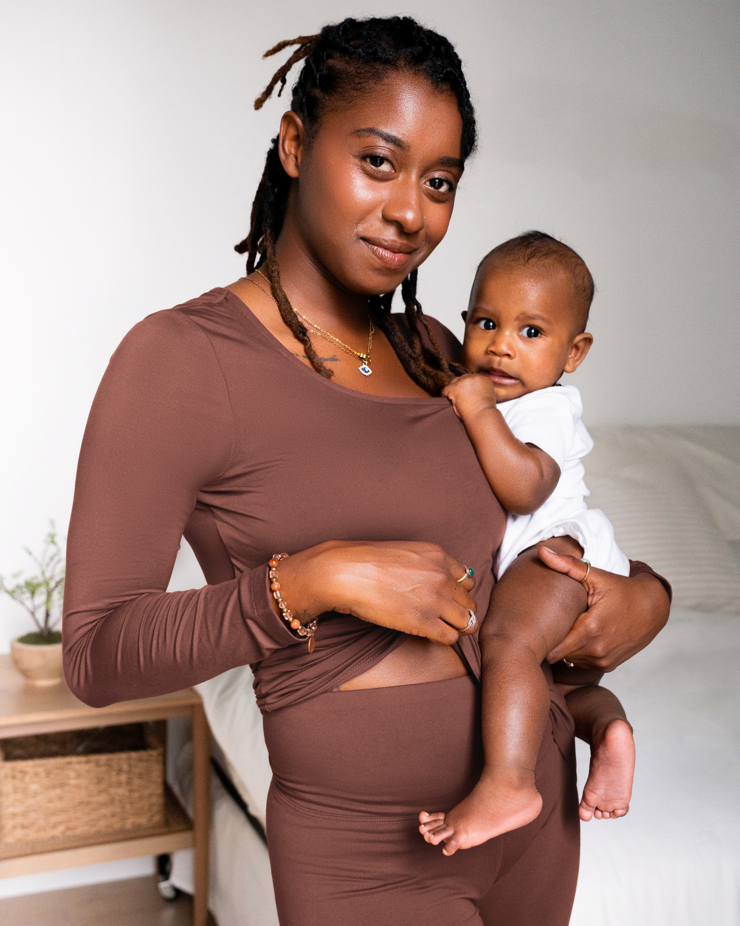 Model wearing the Jane Nursing Pajama Set in Redwood, showing waistband and holding baby. @model_info:Destini is 5'6" and wearing a Medium.