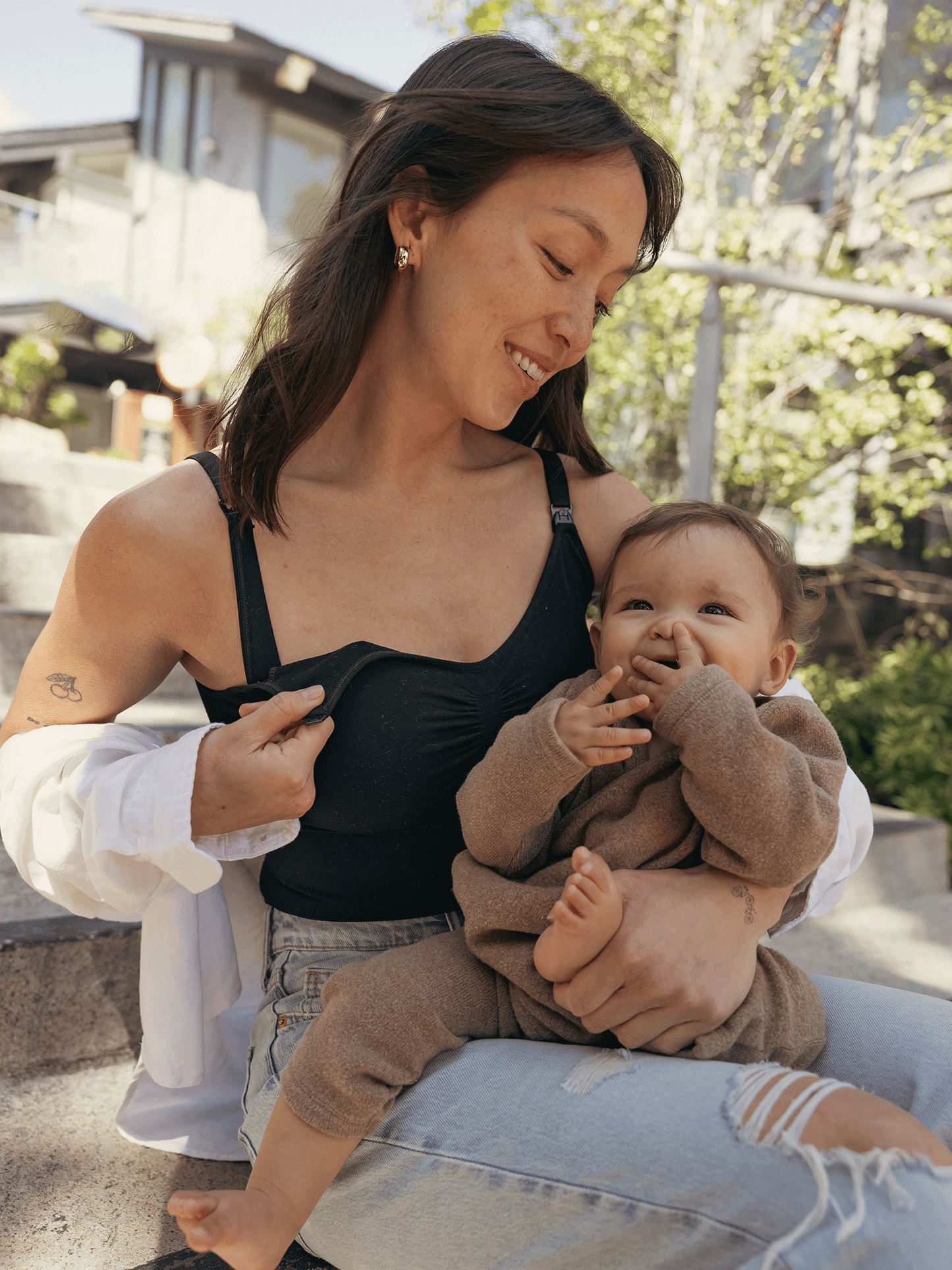 Model wearing the Sublime®️ Bamboo Maternity & Nursing Bodysuit in Black , showing unclipping nursing access. 