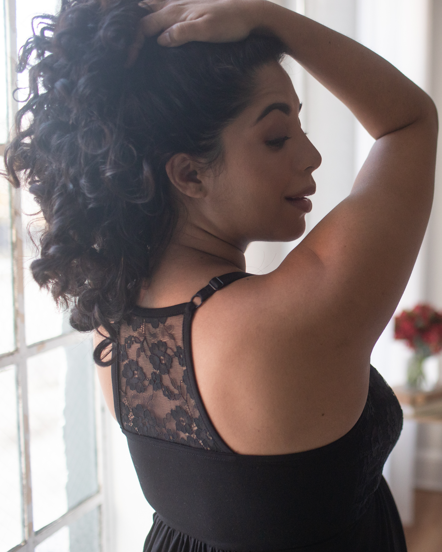 Close up back view of model wearing the Lucille Maternity & Nursing Nightgown in black, showing lace detail.