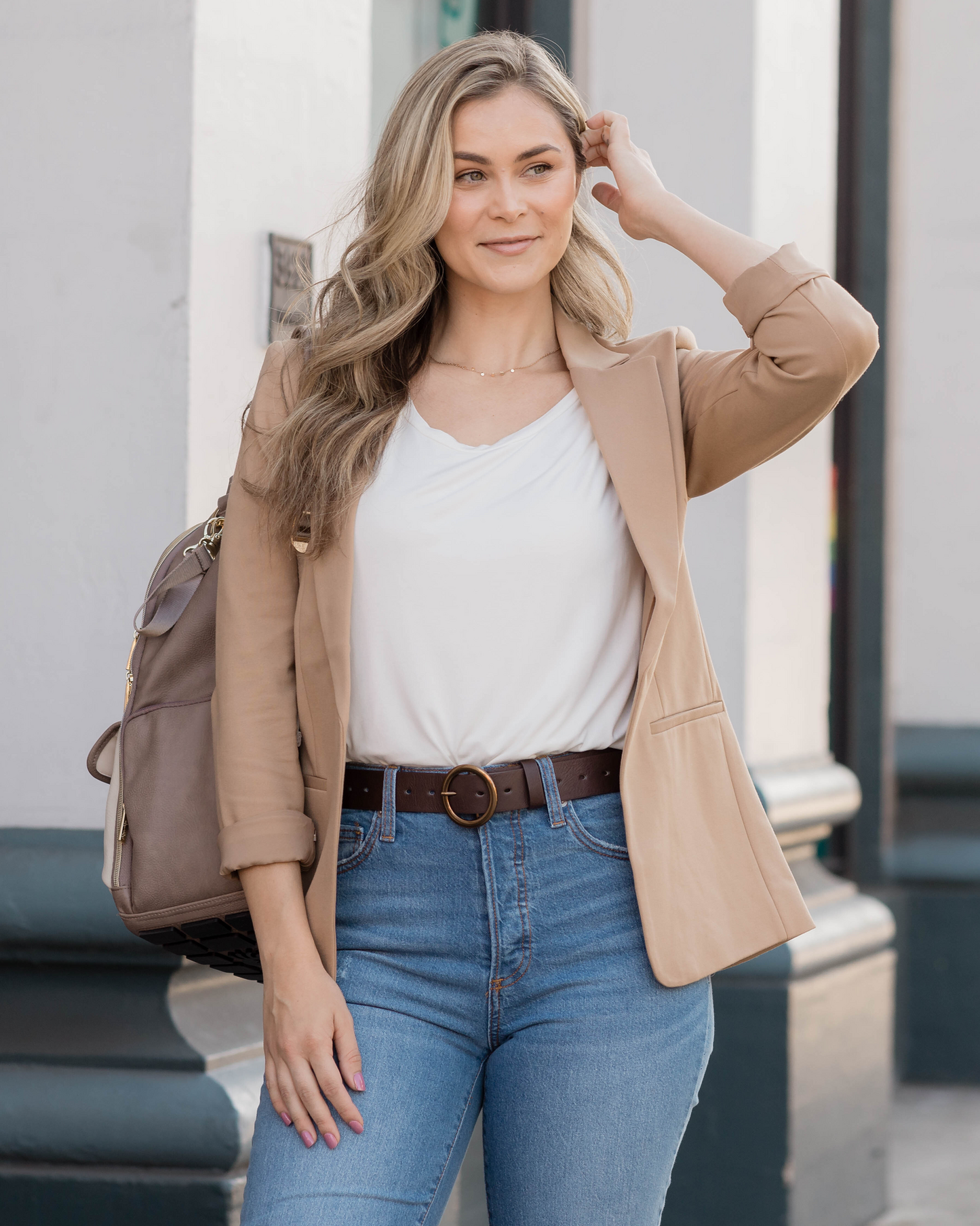 Model standing outside wearing the Everyday Maternity & Nursing T-shirt in White tucked into jeans with a blazer over