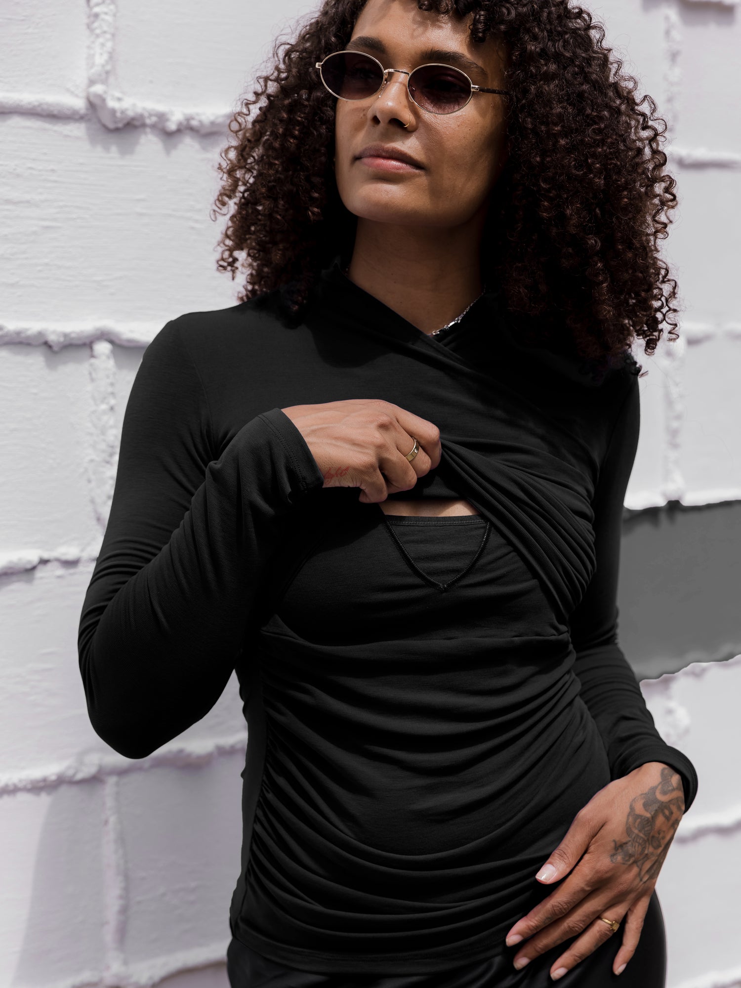 Front view of model outside wearing the Gianna Shirred Maternity & Nursing Top in Black, showing nursing access