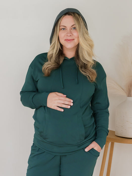 Front view of model wearing the Bamboo Maternity & Nursing Hoodie in Evergreen, with hood on @model_info:Erin is wearing a Medium.