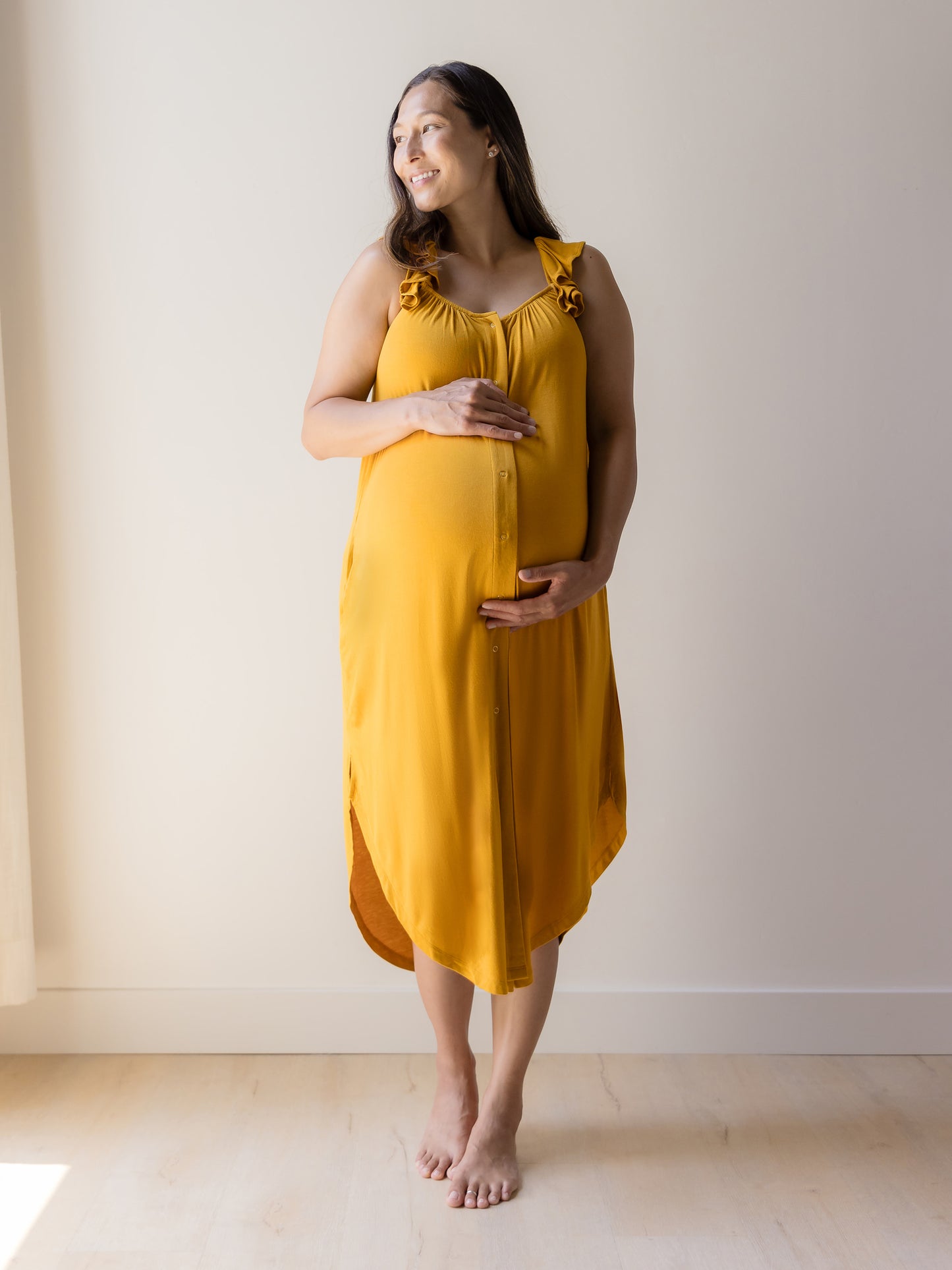 Front view of model wearing the Ruffle Strap Labor & Delivery Gown in Honey. @model_info:Joy is 5'7" and wearing a M/L.