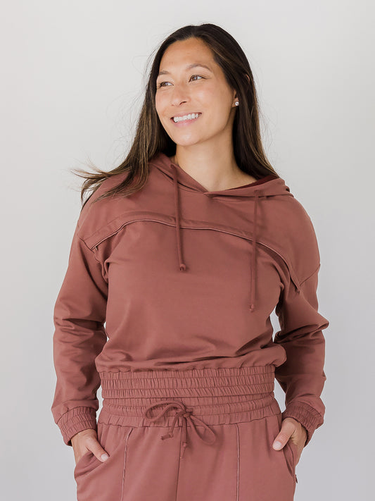 Front view of model wearing the Mila Cropped Nursing Hoodie in Redwood @model_info:Joy is wearing a Medium.