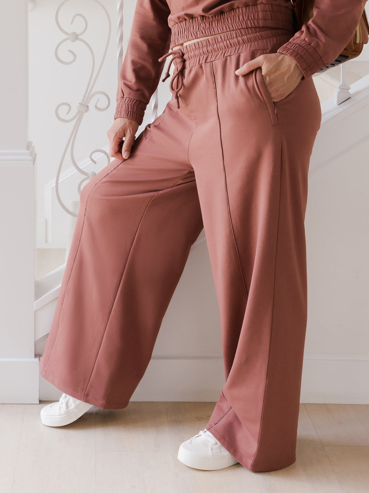 Side cropped in view of model wearing the Mila Wide Leg Pant in Redwood