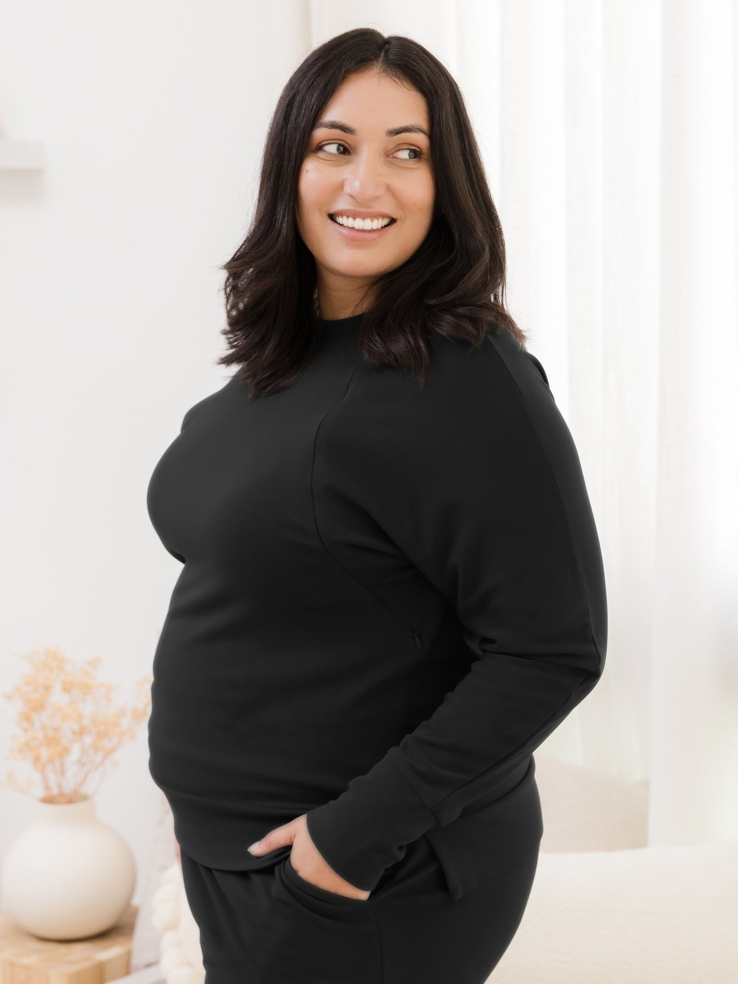 Side view of model wearing the Bamboo Maternity & Nursing Crew Neck Sweatshirt in Black.