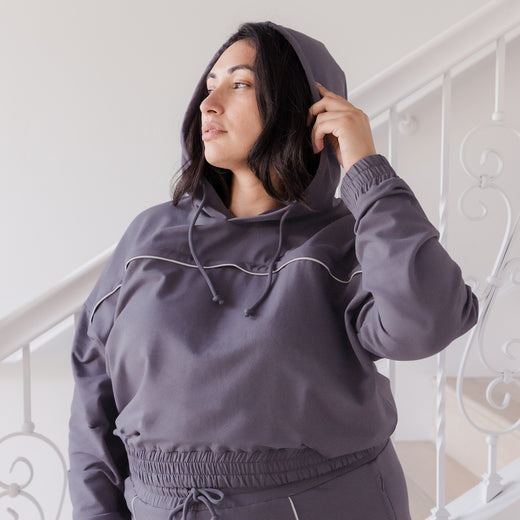 Model wearing the Mila Cropped Nursing Hoodie in Granite, with hood on