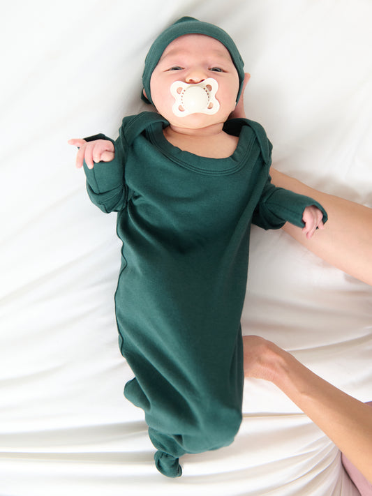 Newborn wearing the Baby Knotted Gown & Hat Set in Evergreen.