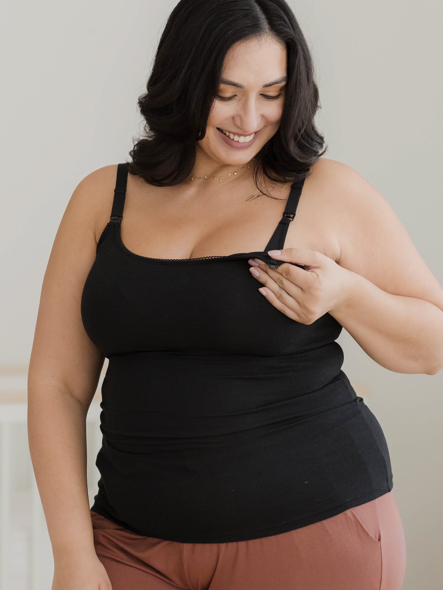 Cropped in image of model wearing the Picot Trim Nursing Camisole in Black, showing nursing access.