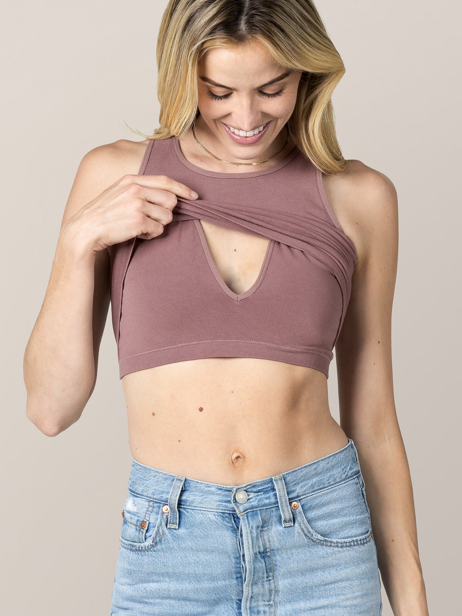 Front view of model wearing the Sublime® Bamboo Maternity & Nursing Longline Bra in Twilight, lifting up outer layer to show nursing access.