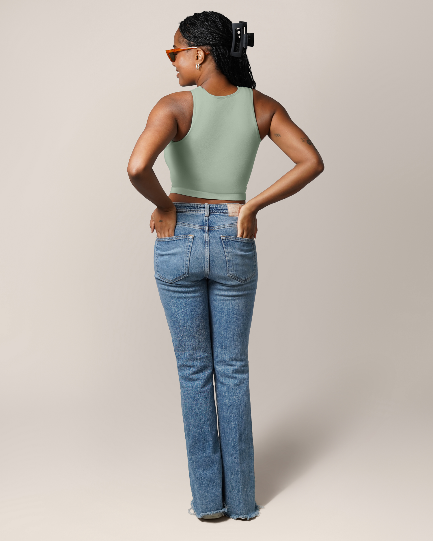 Full body back view of model wearing the Sublime® Bamboo Maternity & Nursing Longline Bra Top in Aqua Mist, paired with jeans 