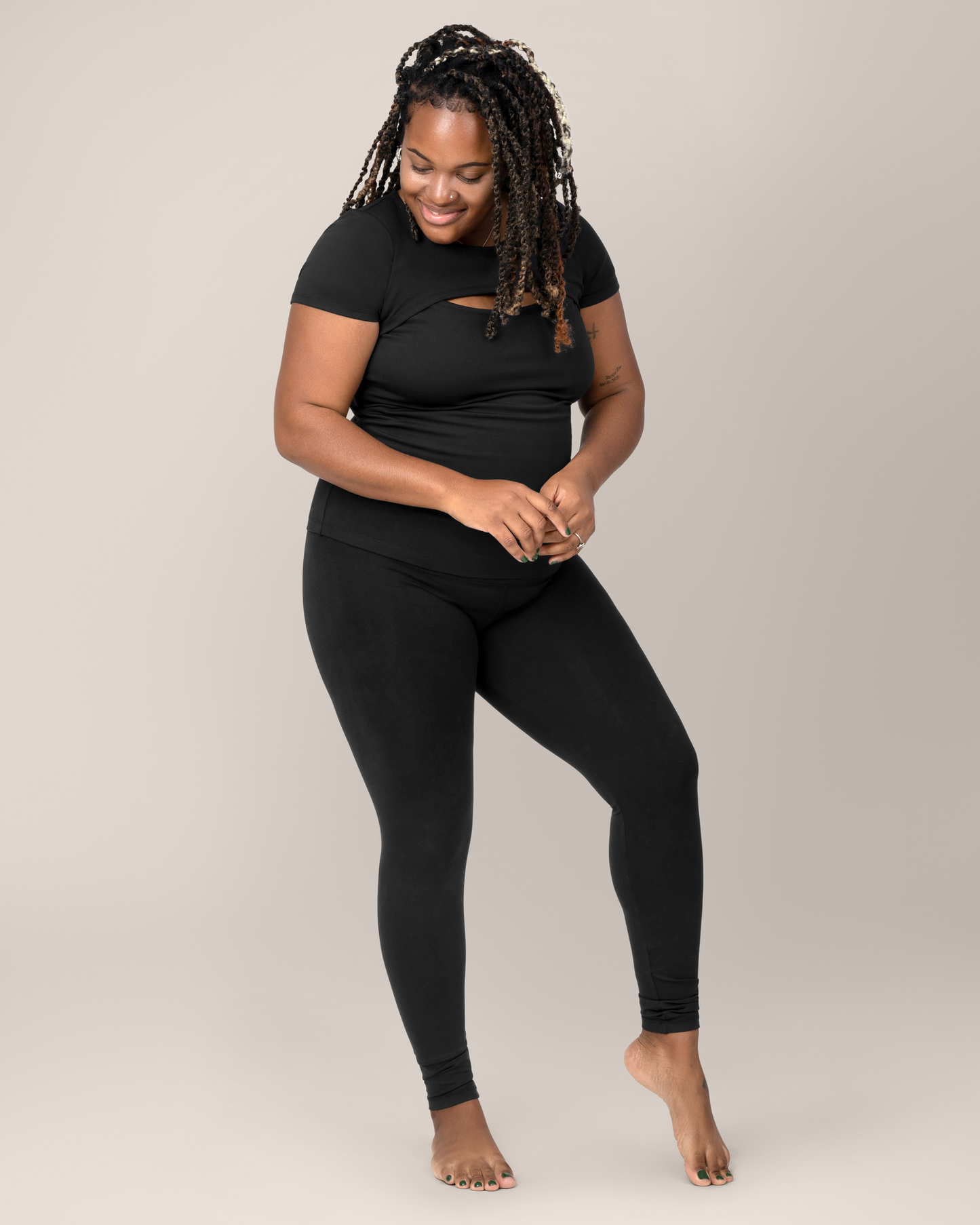 Model wearing the Luna  Active Cut Out Nursing Top in Black with matching leggings