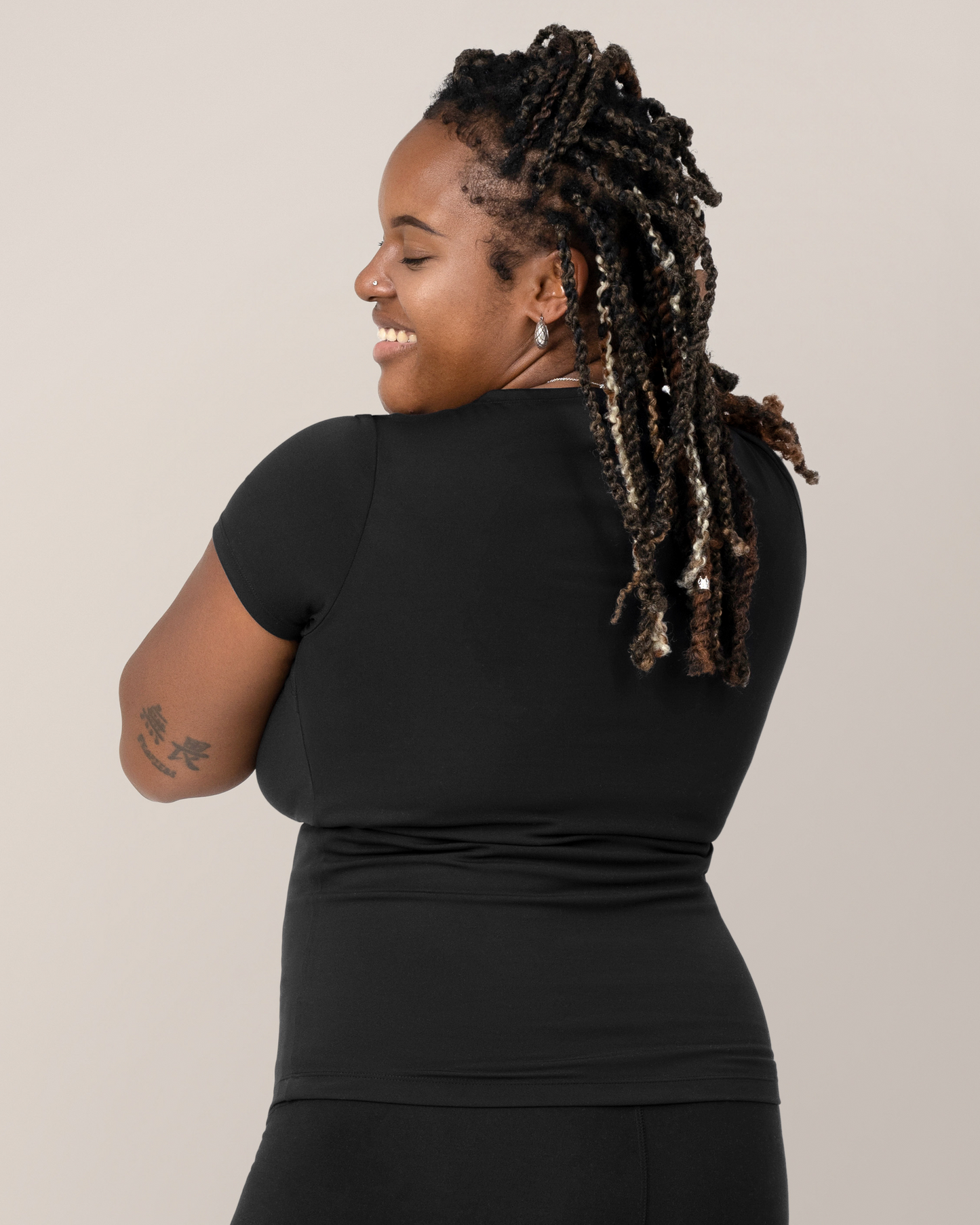 Back view of model wearing the Luna  Active Cut Out Nursing Top in Black 