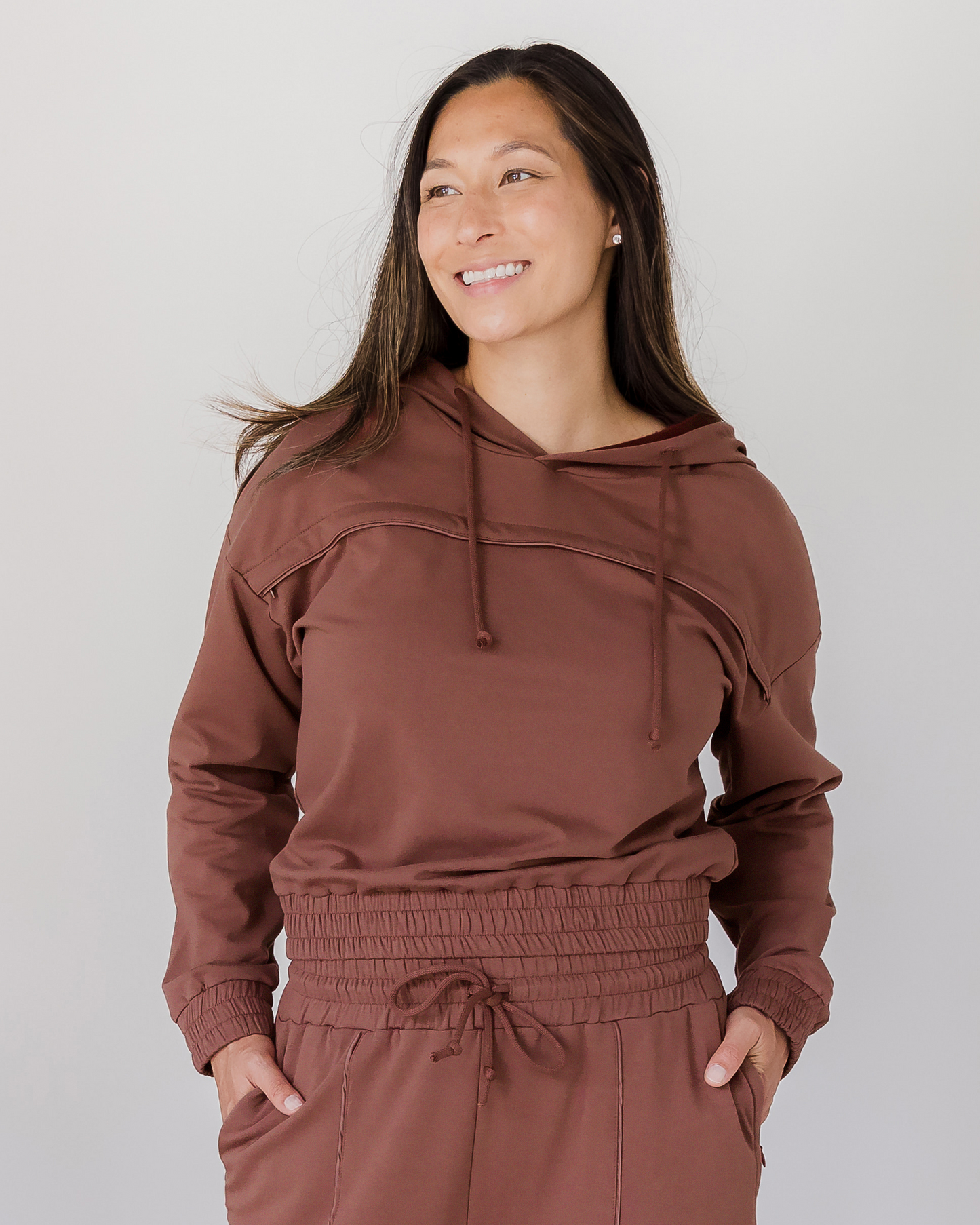 Front view of model wearing the Mila Cropped Nursing Hoodie in Redwood @model_info:Joy is wearing a Medium.