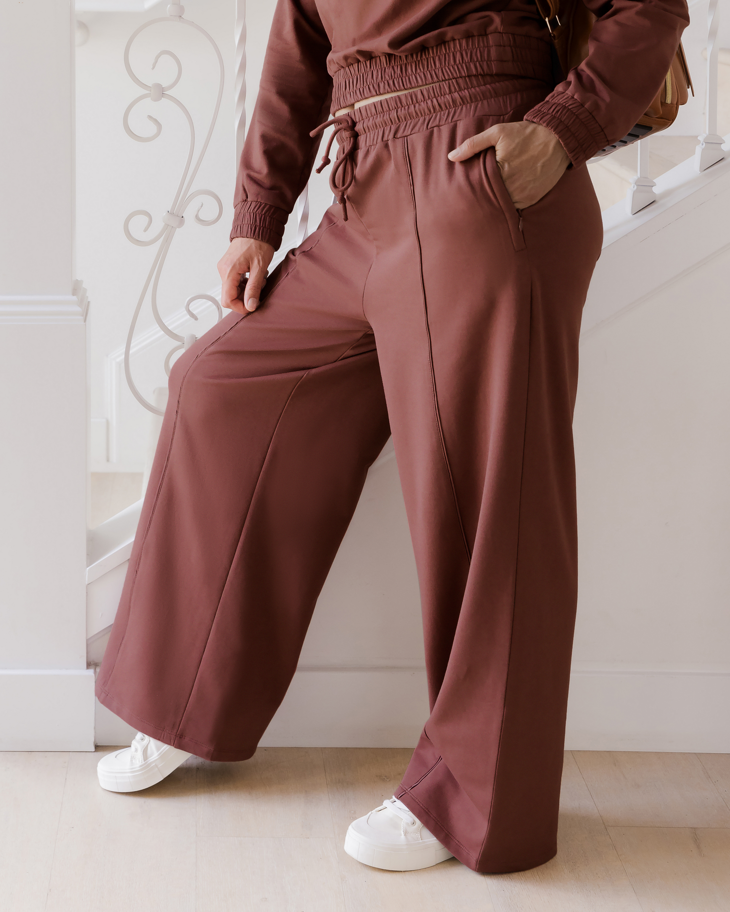 Side cropped in view of model wearing the Mila Wide Leg Pant in Redwood