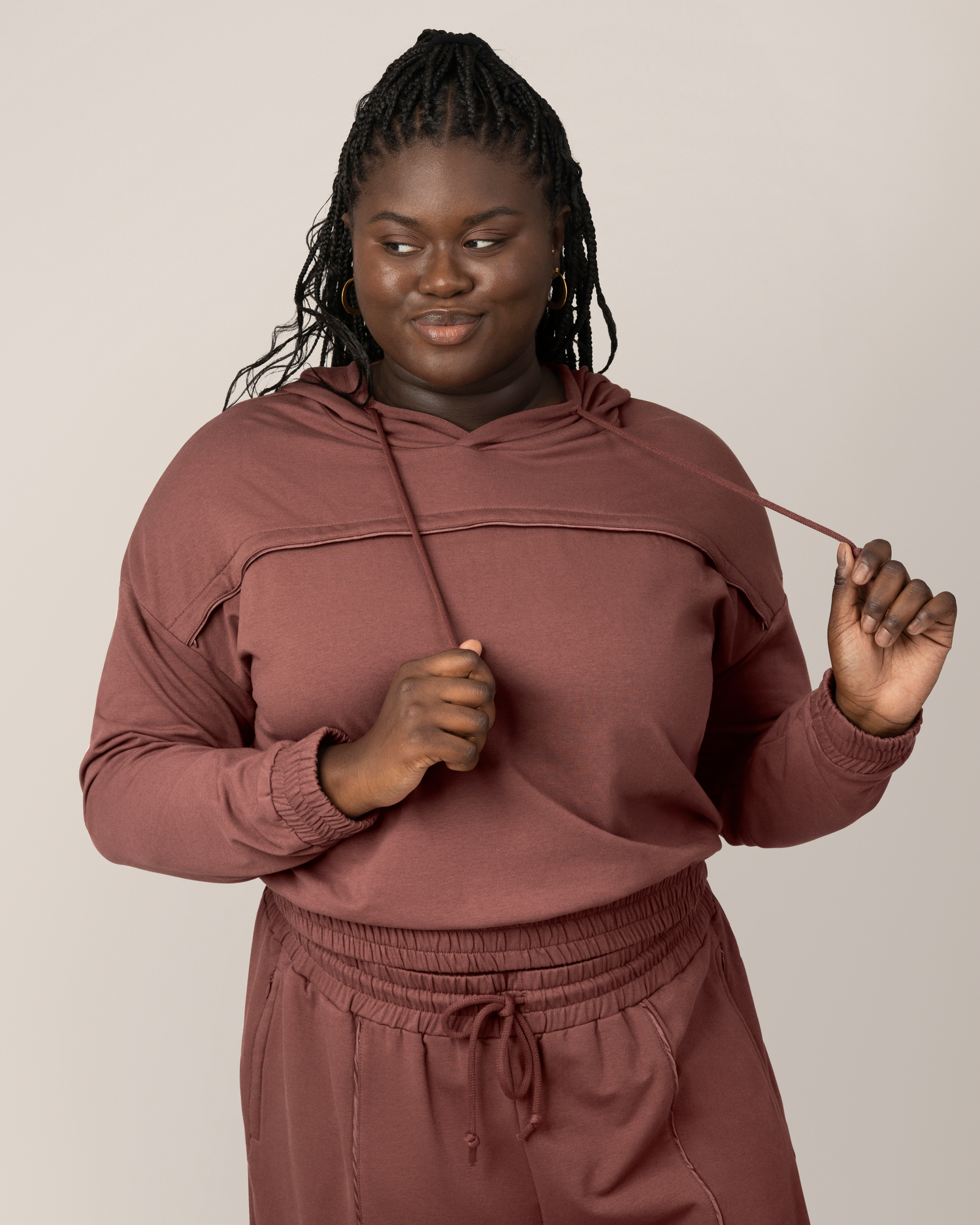 Front view of model wearing the Mila Cropped Nursing Hoodie in Redwood