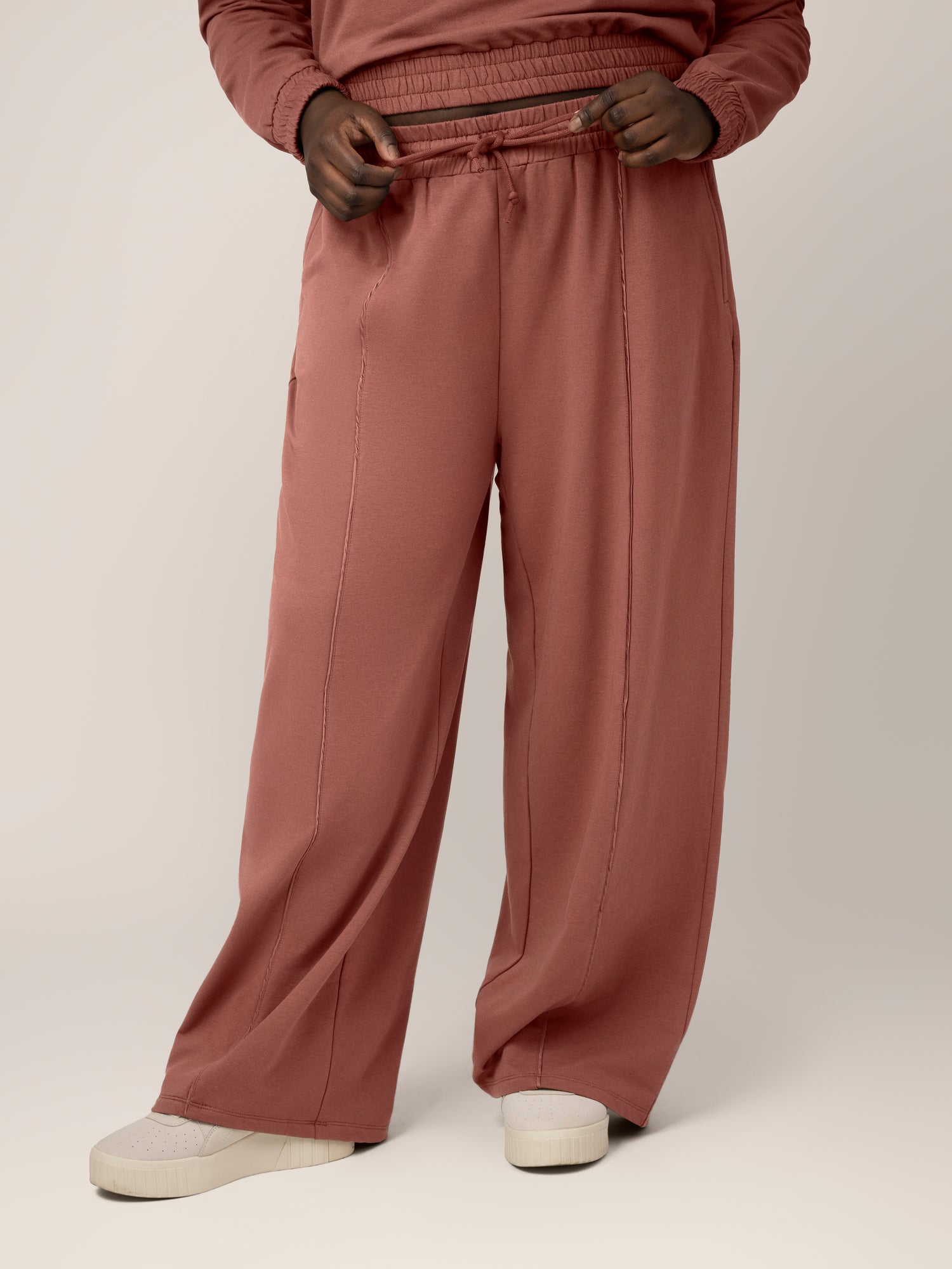  Front view of model wearing the Mila High-Waisted Wide Leg Pant in Redwood. @model_info:Bintou is 5'9" and wearing an X-Large Long.