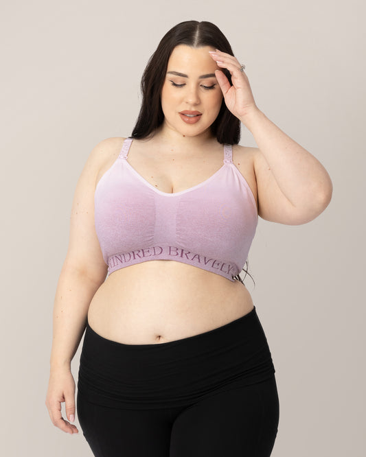 Model wearing the Sublime® Hands-Free Pumping & Nursing Sports Bra  in Ombre Purple with her hand on her hair. @model_info:Rachel is wearing a X-Large Busty.