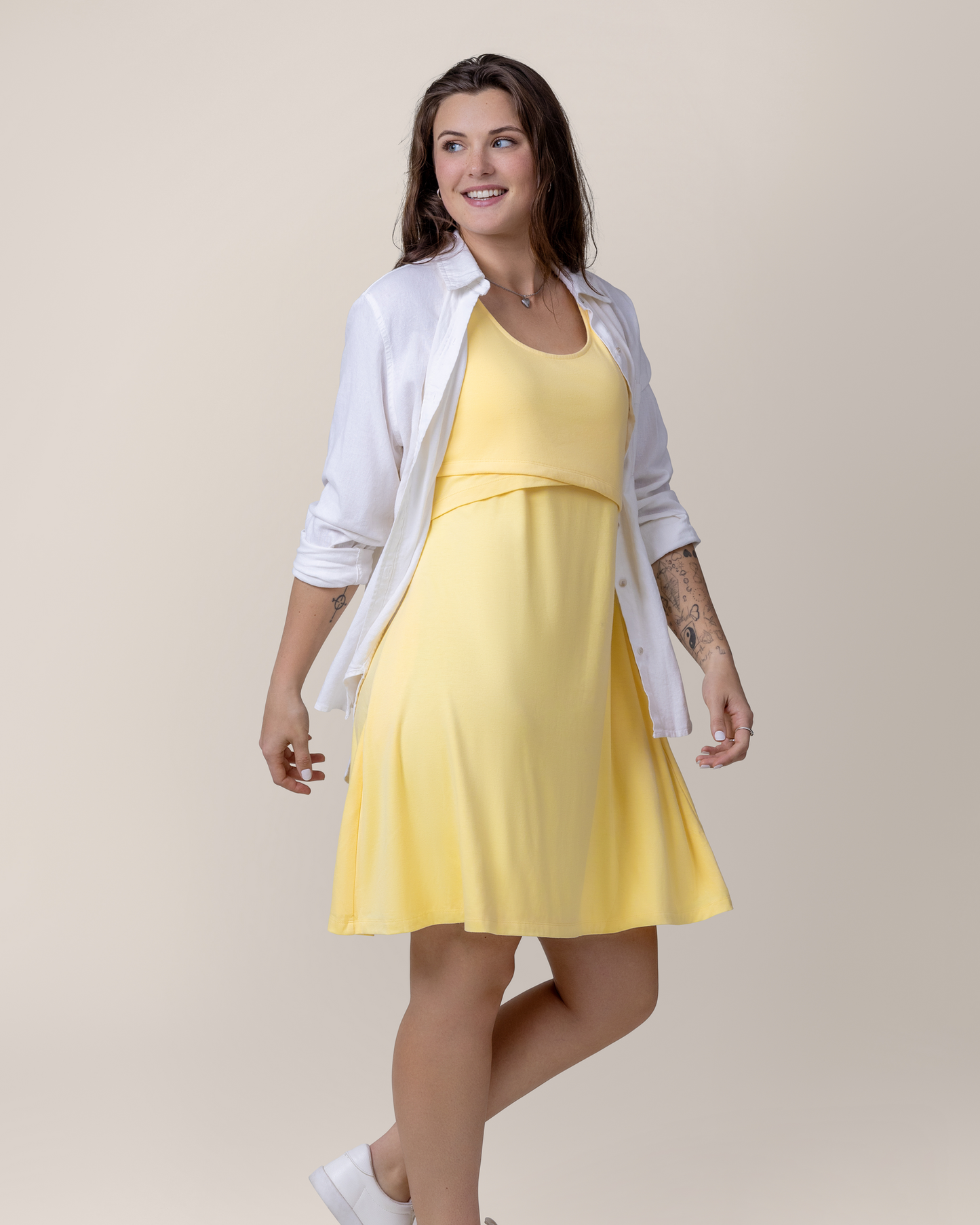 Front view of model wearing the Penelope Crossover Nursing Dress in Butter Yellow 