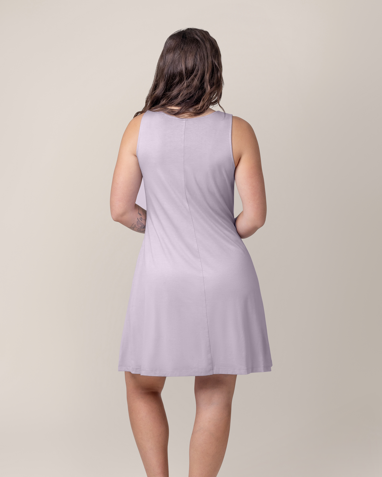 Back view of model wearing the Penelope Crossover Nursing Dress in Lavender Mist 