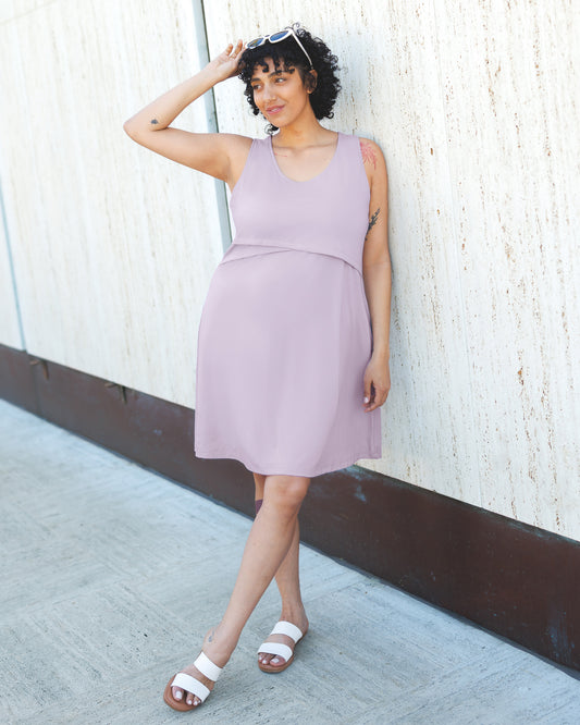 Front view of model outside wearing the Penelope Crossover Nursing Dress in Lavender Mist@model_info:Indira is 5'8" and wearing a Large.