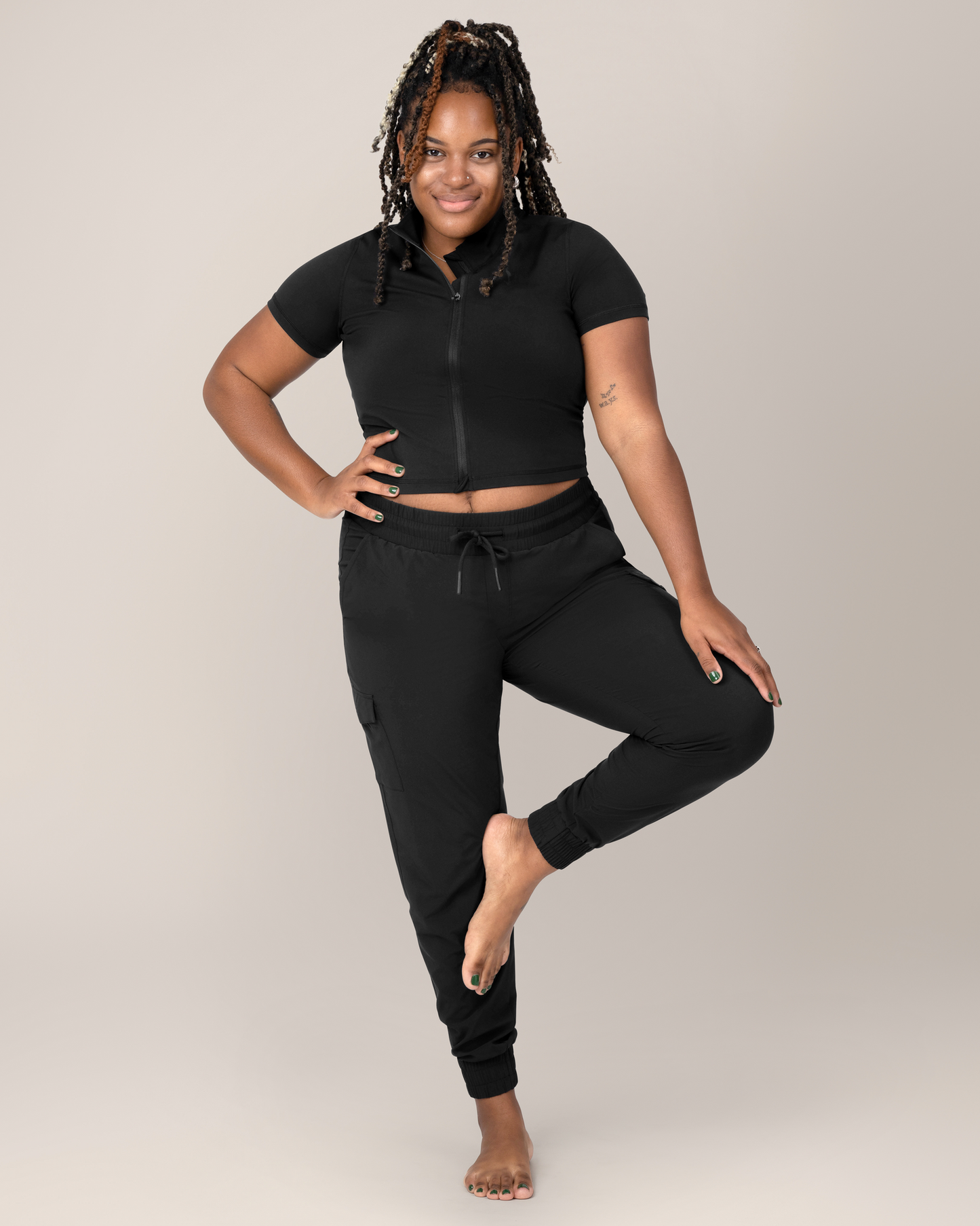 Front view of Model wearing the Presley Active Zip Front Nursing Top in Black with matching Remy Maternity & Postpartum Cargo Jogger @model_info:Tonia is wearing a Large.