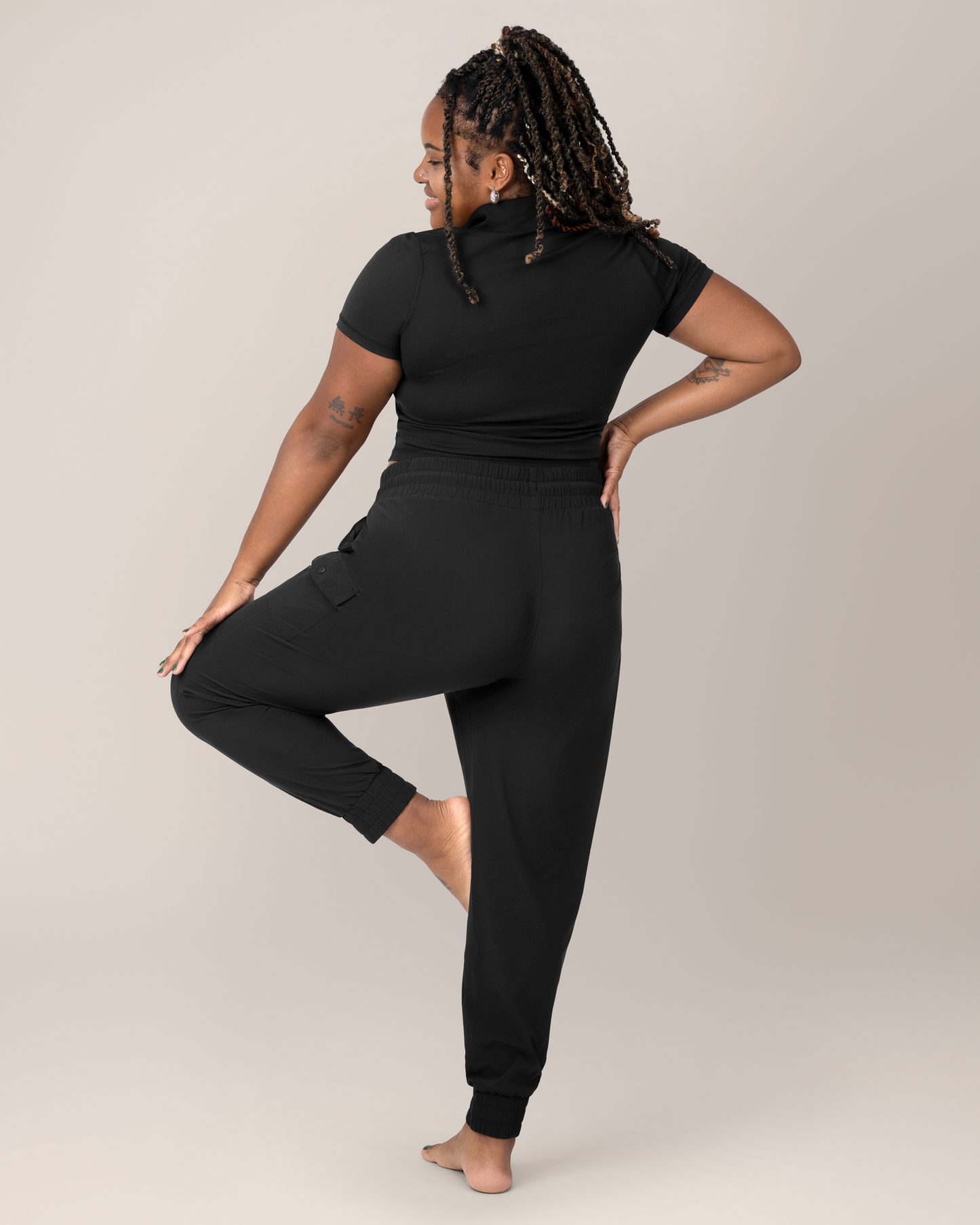 Back view of Model wearing the Remy Maternity & Postpartum Cargo Jogger in Black 