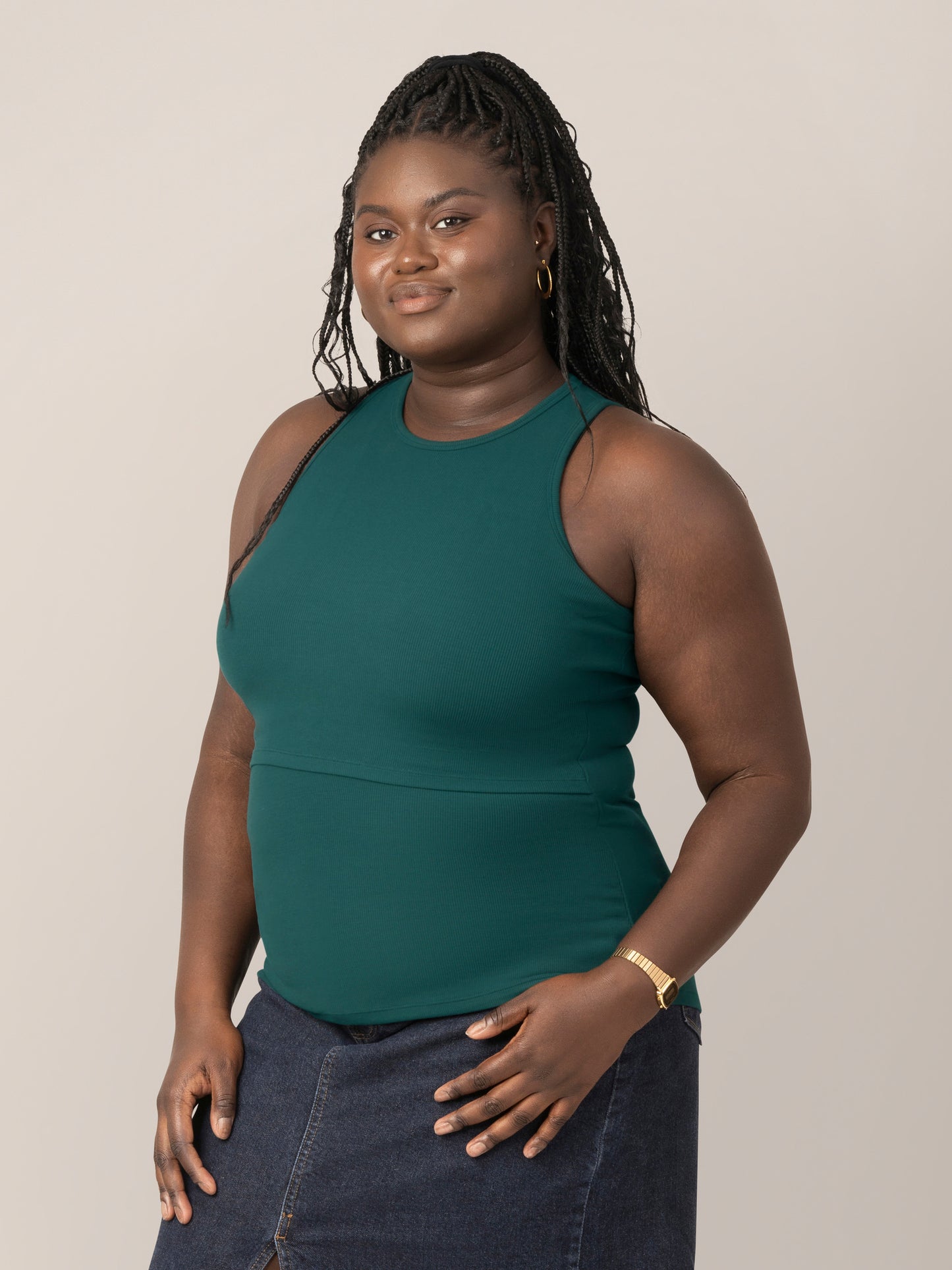 Front 3/4 view of model wearing the Ribbed Bamboo Racerback Nursing Tank in evergreen @model_info:Bintou is wearing an X-Large.