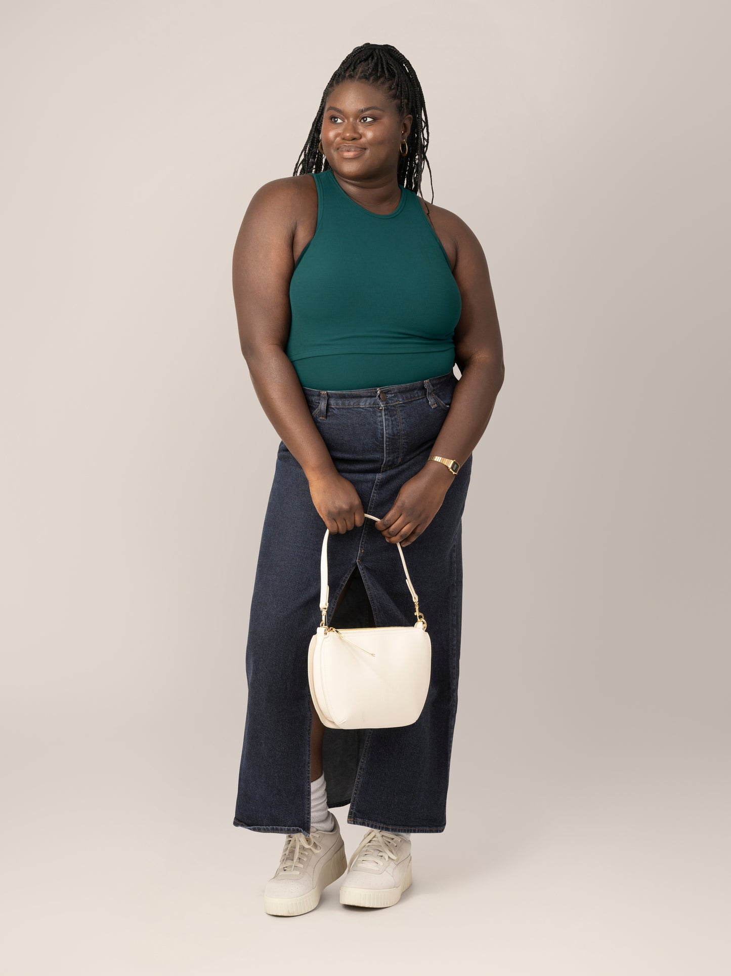 Front full body view of model wearing the Ribbed Bamboo Racerback Nursing Tank in evergreen, paired with long dark denim skirt and tennis shoes