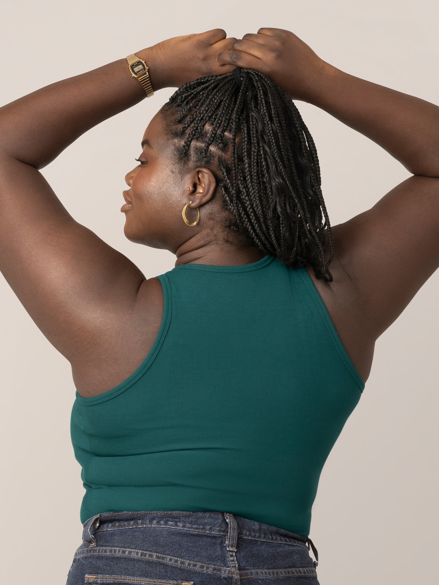 Back view of model wearing the Ribbed Bamboo Racerback Nursing Tank in evergreen, with hands over head