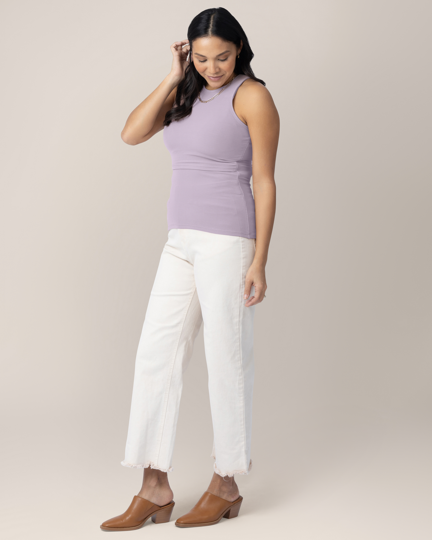 Model wearing the Ribbed Bamboo Racerback Nursing Tank in Lavender Mist paired with white cropped jeans