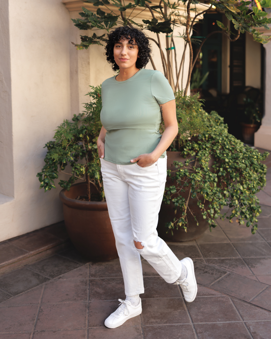 Model wearing Ribbed Bamboo Crew Neck Nursing T-shirt in Aqua Mist paired with cropped white jeans and white tennis shoes @model_info:Indira is wearing an X-Large.