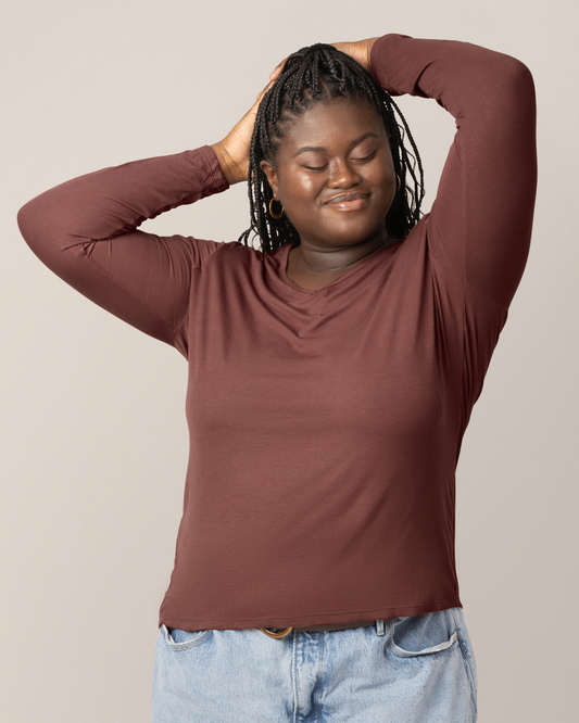 Front view of model wearing the Ribbed Bamboo Maternity & Nursing Long Sleeve T-shirt in Redwood, with hands on head @model_info:Bintou is wearing an X-Large.