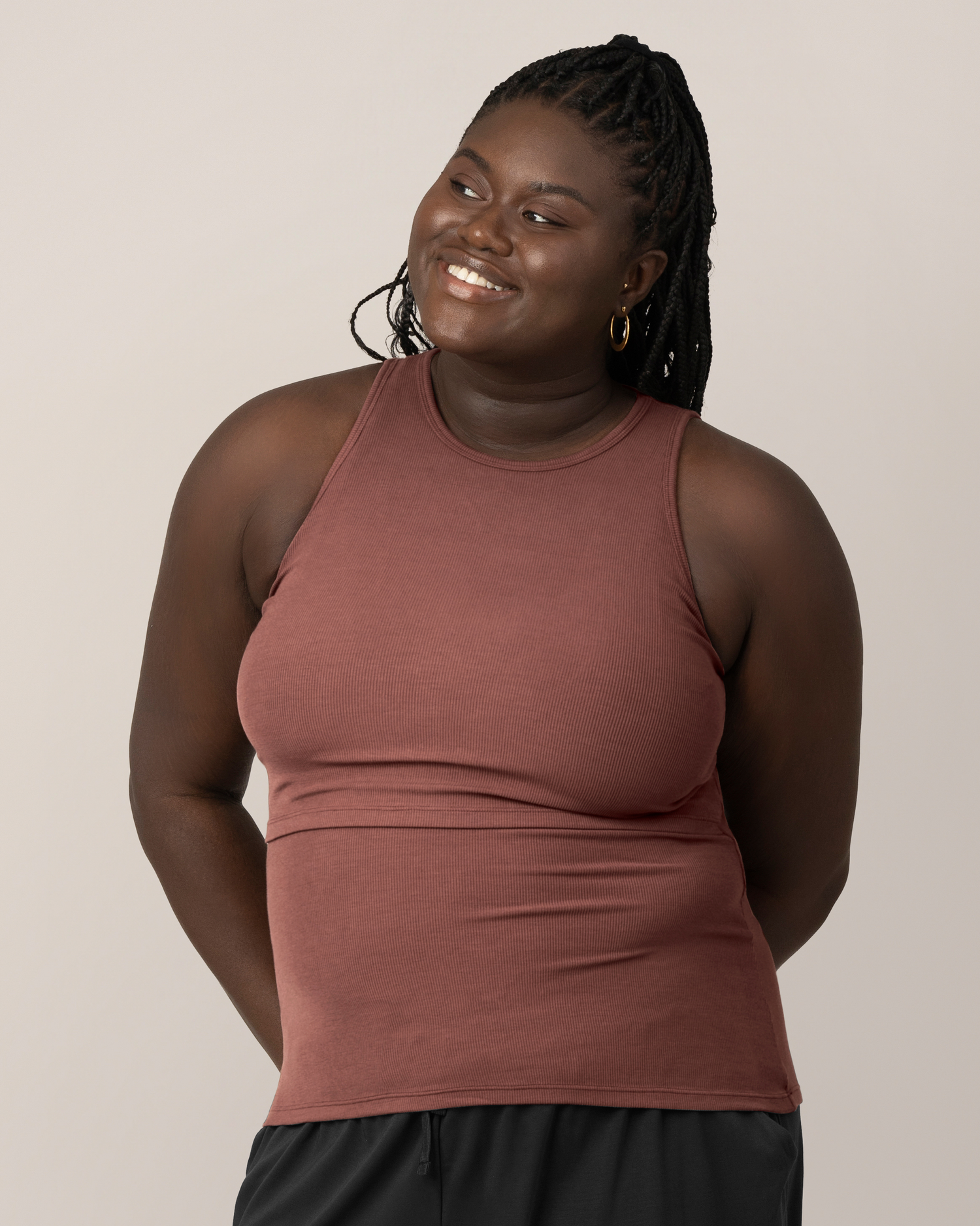 Front view of model wearing the Ribbed Bamboo Racerback Nursing Tank in Redwood, with hands behind back