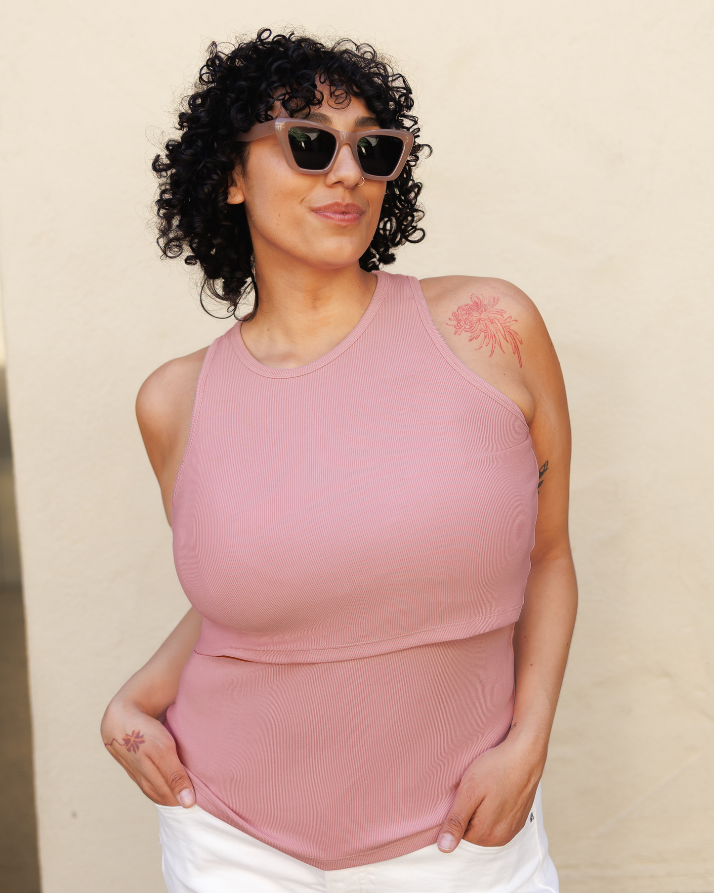 Model outside wearing the Ribbed Bamboo Racerback Nursing Tank in Light Mauve@model_info:Indira is wearing an X-Large.