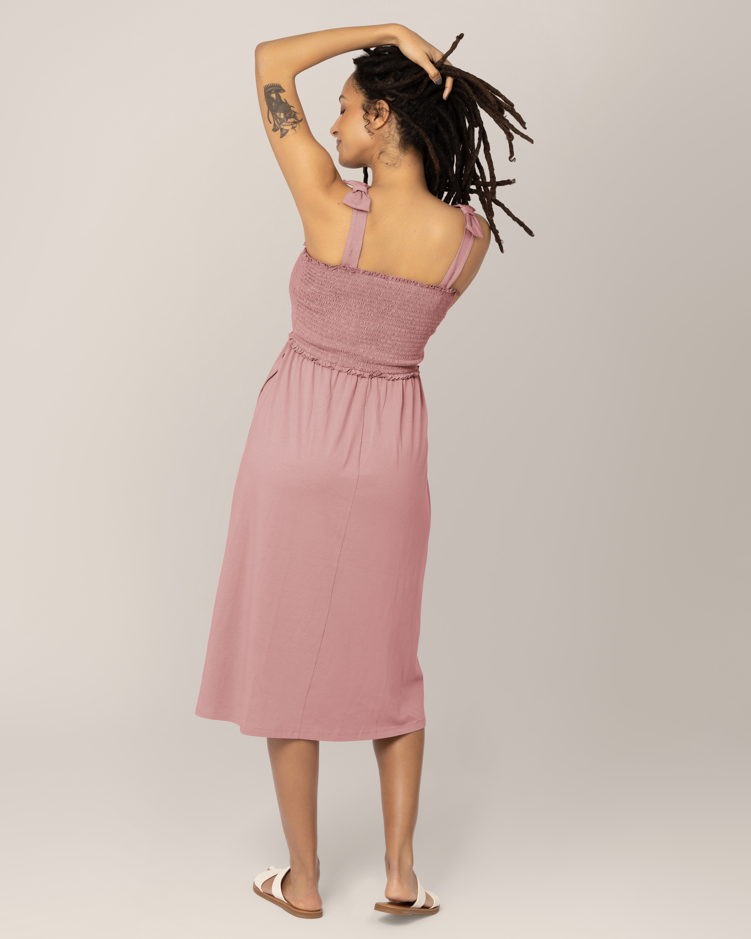 Back view of model wearing the Sienna Smocked Maternity & Nursing Dress in Light Mauve