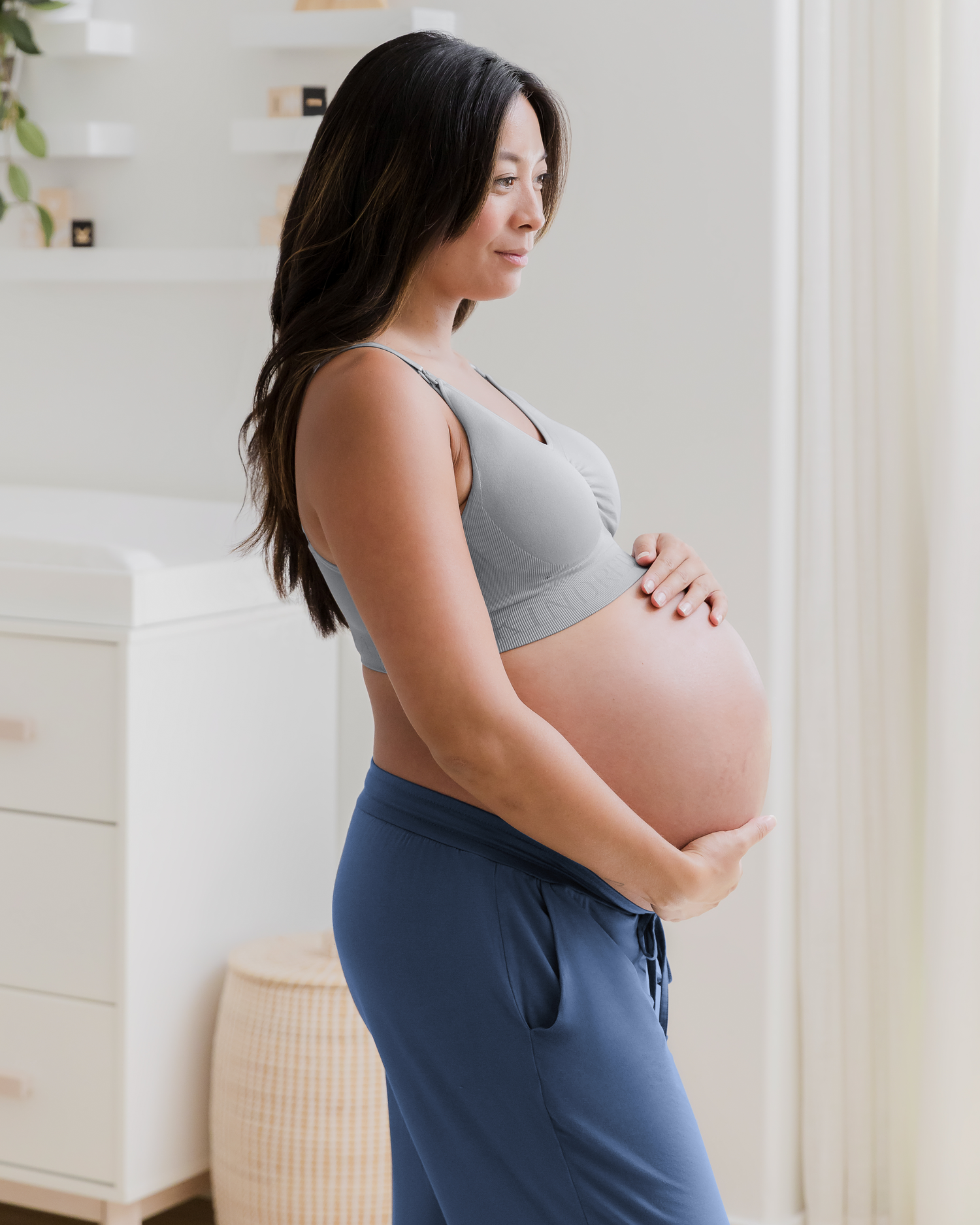 Side view of pregnant model wearing the Simply Sublime Nursing bra paired with Everyday Lounge Jogger in Slate Blue